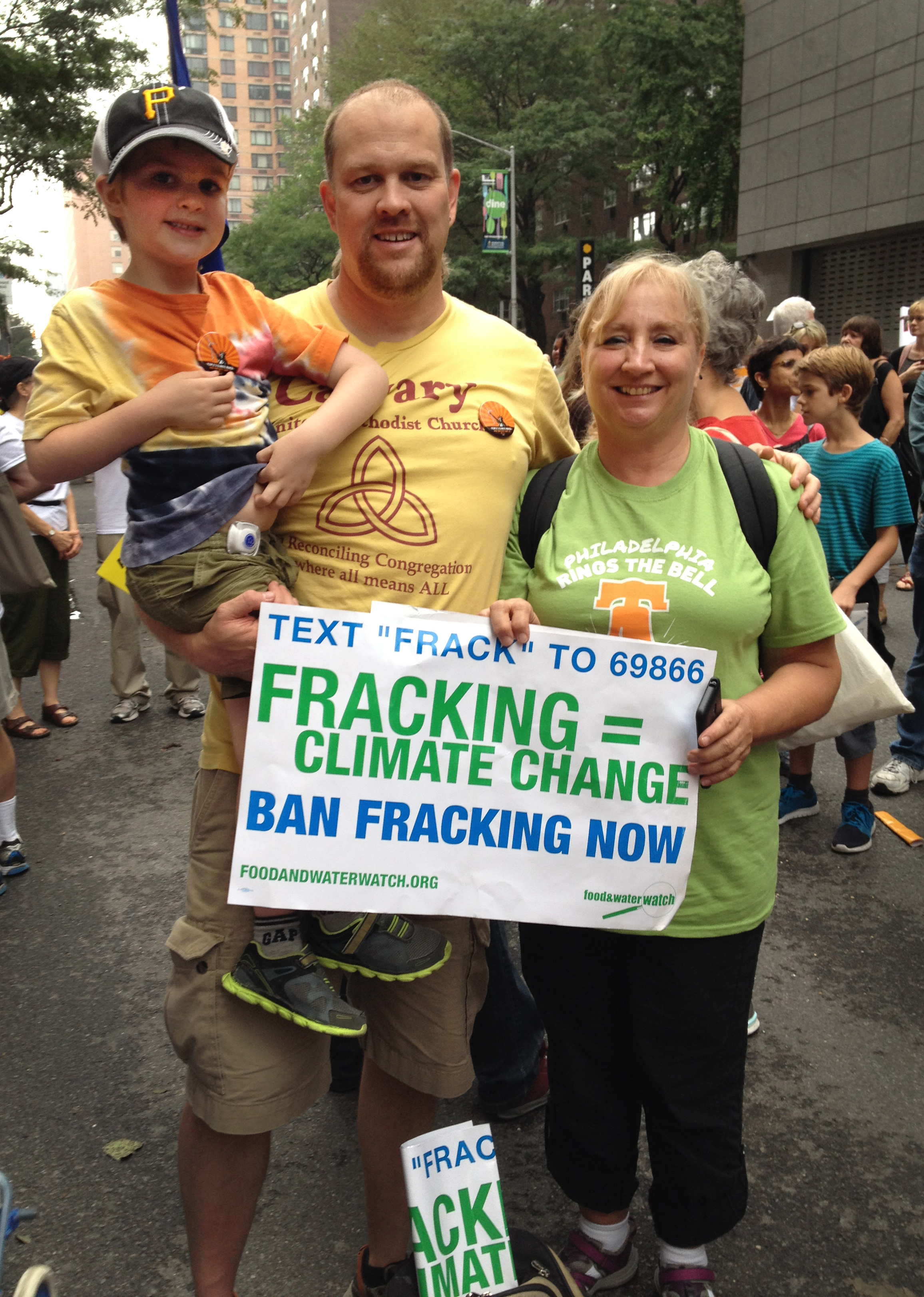 Tim Emmett-Rardin, left, holding his son, Gabriel, and Gerry Felix, members of Calvary United Methodist Church in Philadelphia, were among the United Methodists who traveled to New York Sept. 21 for the Peoples Climate March. Photo by Linda Bloom, UMNS