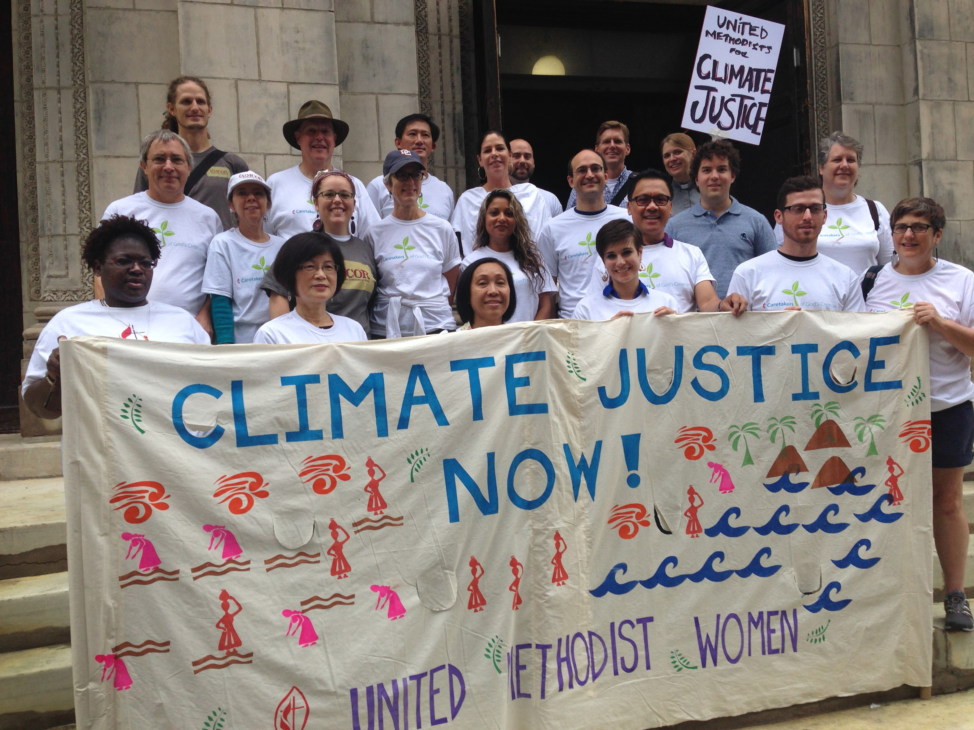 One group of United Methodists participating in the People's Climate March Sept. 21 gather on the steps of the United Methodist Church of Saint Paul and Saint Andrew. Photo by Linda Bloom, UMNS