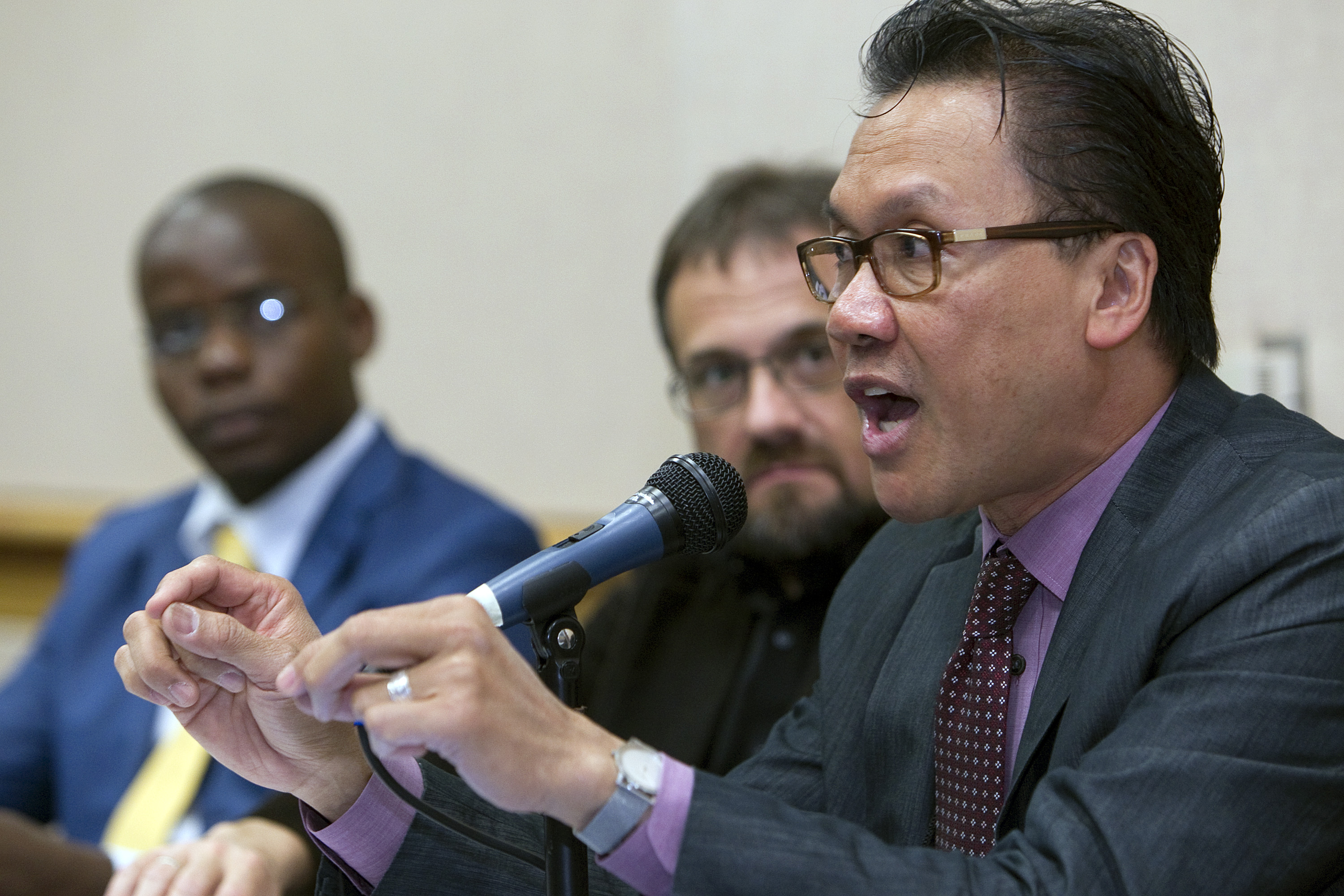 The Rev. Liberato Bautista (right) helps lead a discussion of social issues during a briefing for international delegates at the 2012 United Methodist General Conference in Tampa, Fla. Photo by Mike DuBose, UMNS