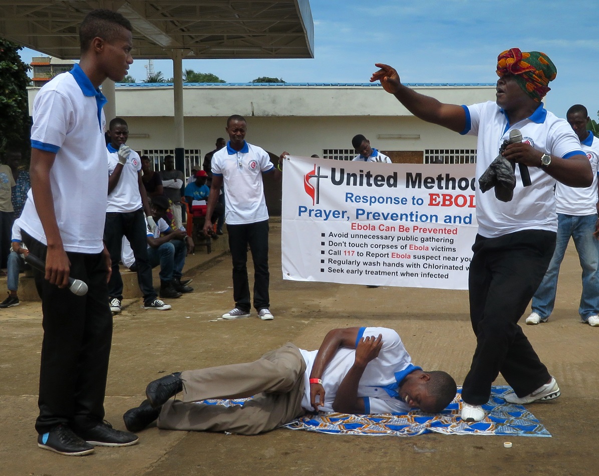 Young adults from the Sierra Leone Annual Conference act out skits relating the Ebola virus prevention and treatment in effort to educate. 