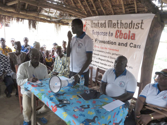 The Rev. Winston Ashcroft brings greetings to the people of Mamakah, Sierra Leone, from Bishop John Yambasu. He educates them about ways to combat Ebola and prays with them. 