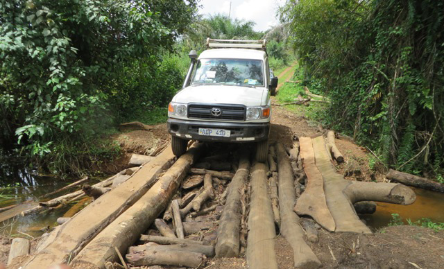 A vehicle carrying the Ebola Response team of The United Methodist Church in Sierra Leone makes its way across a rough bridge on the way to the village of Moyollo. The team was bringing educational and sanitation materials to fight Ebola. Photo by Phileas Jusu, UMNS
