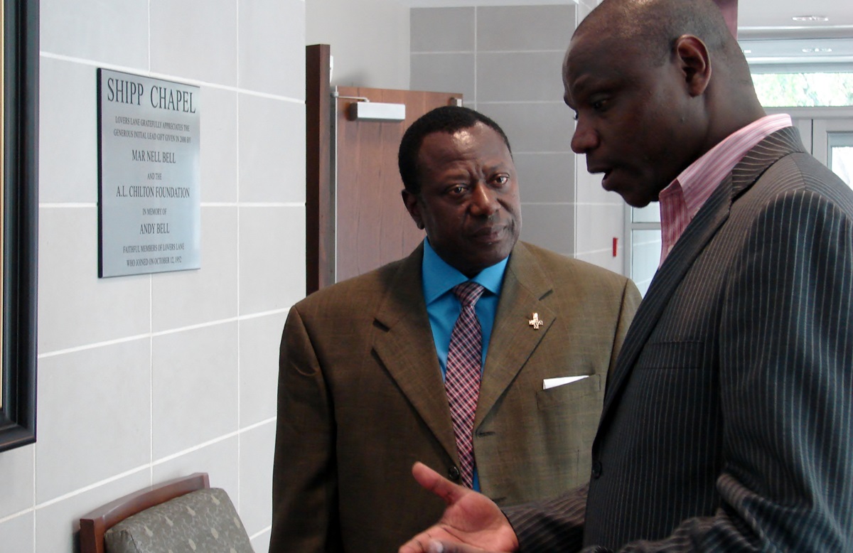 Eric Pratt (left) and the Rev. Jacob Keega confer after an Oct. 19 worship service. Pratt, lay leader of the Heart of Africa Fellowship, and Keega, the fellowship’s pastor, have worked on the church’s response to the Ebola crisis in West Africa. 