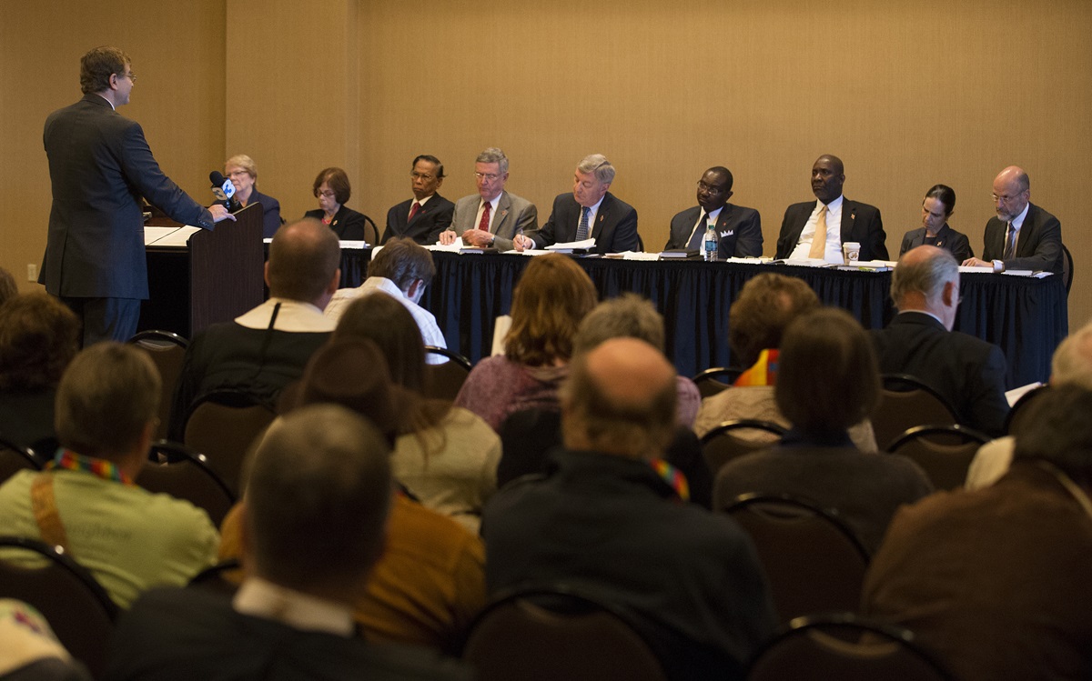 The Rev. Christopher Fisher (left) addresses the United Methodist Judicial Council which will decide whether to uphold the reinstatement of the Rev. Frank Schaefer, who lost his credentials after being found guilty in a church trial last November of performing a same-sex wedding ceremony for his son. An oral hearing on the matter opened the council’s Oct. 22-25 fall meeting in Memphis, Tenn. Fisher serves as counsel for the church.