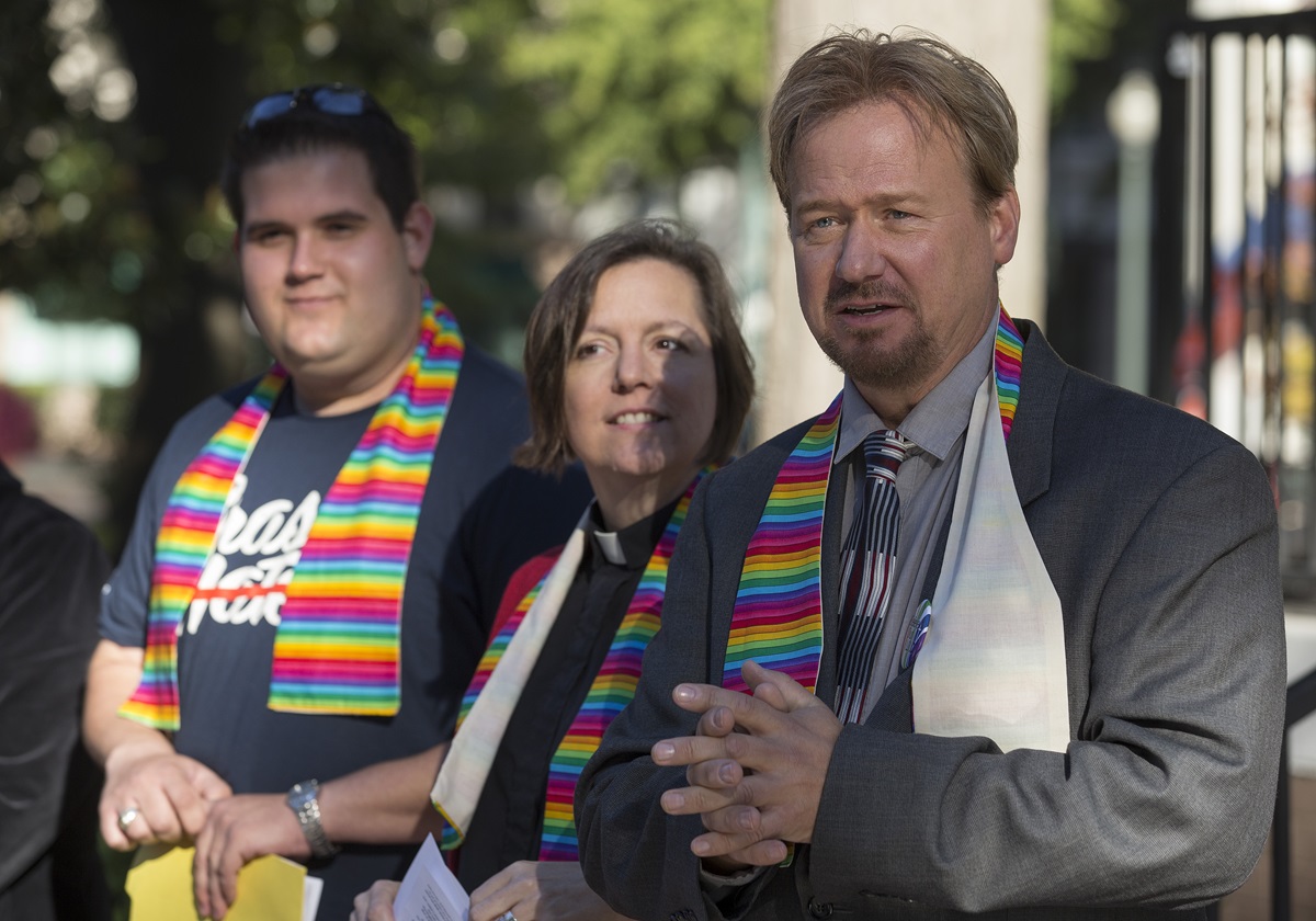 The Rev. Frank Schaefer (right) greets supporters during a prayer service for unity at Court Square Park in Memphis, Tenn., prior to his appearance before the United Methodist Judicial Council.
