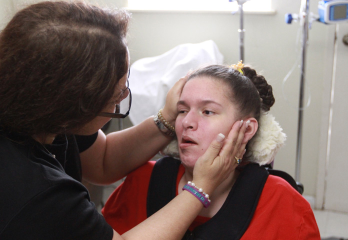 Ann Brownell tends to daughter Amanda, today living as a paraplegic in a San Jose, Calif., nursing home. Photos by Reed Galin. 