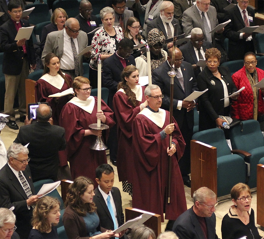 Dave Attaway, member of St. Luke’s United Methodist Church in Oklahoma City, carries the cross during the Nov. 2 processional for the Service of Remembrance and Celebration of Hope during the Council of Bishops meeting. Photo by Holly McCray