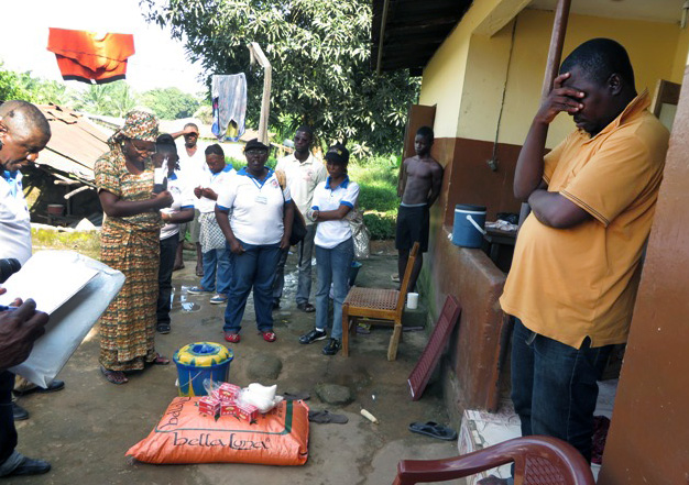 Mohamed Dumbuya is  overcome with emotion when the team from The United Methodist Sierra Leone Conference arrives with gifts of food and words of consolation for the passing of his wife, Mariatu Kamara, who recently died from Ebola. 