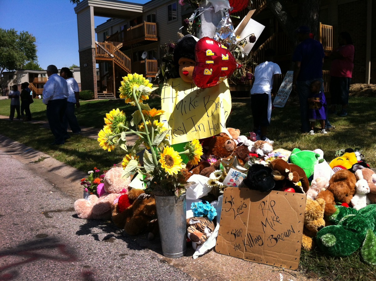 An impromptu memorial marks the area where Michael Brown was killed in Ferguson, Mo. Photo by Matt Miofsky.