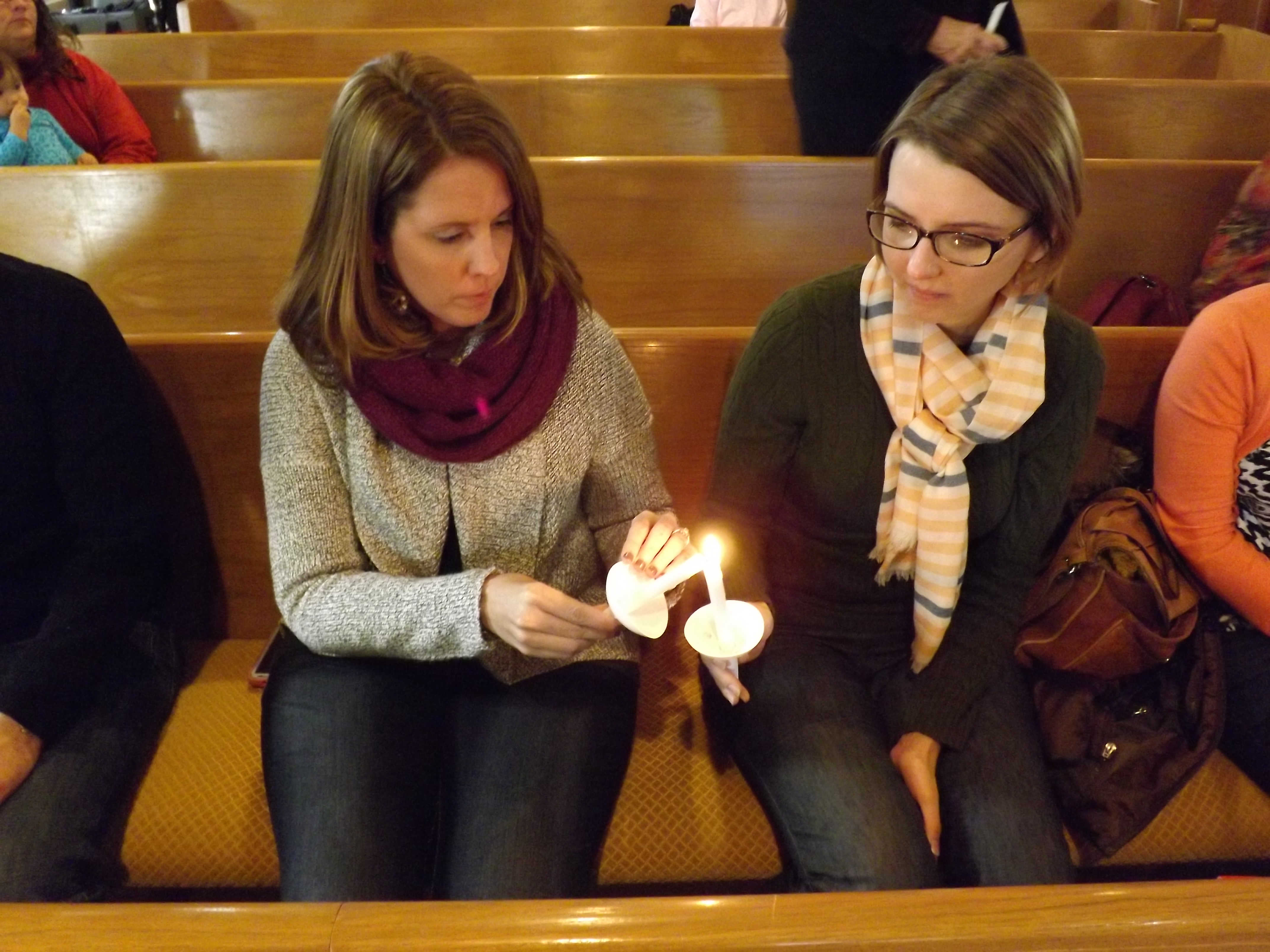 Nicole Hornbaker (left) and Megan Griffiths attend a prayer service for Dr. Martin Salia at Hanscom Park United Methodist Church in Omaha, Neb., Nov. 16. Salia, chief medical officer and surgeon at United Methodist Kissy Hospital in Freetown, Sierra Leone, died at Nebraska Medical Center Nov. 17 from Ebola. 