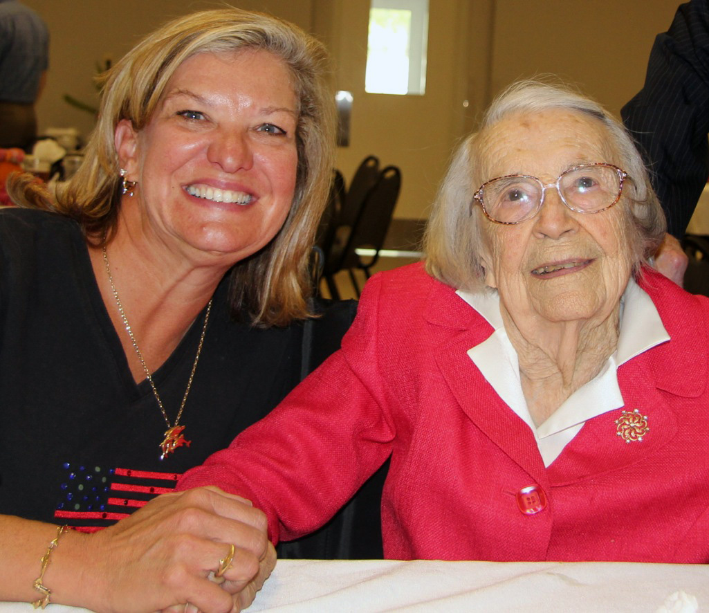 Dawn Wiggins Hare visits with Alice Finch Lee during a celebration for Lee’s 100th birthday at First United Methodist Church in Monroeville, Ala. Photo by Marianne Lee, a family member.