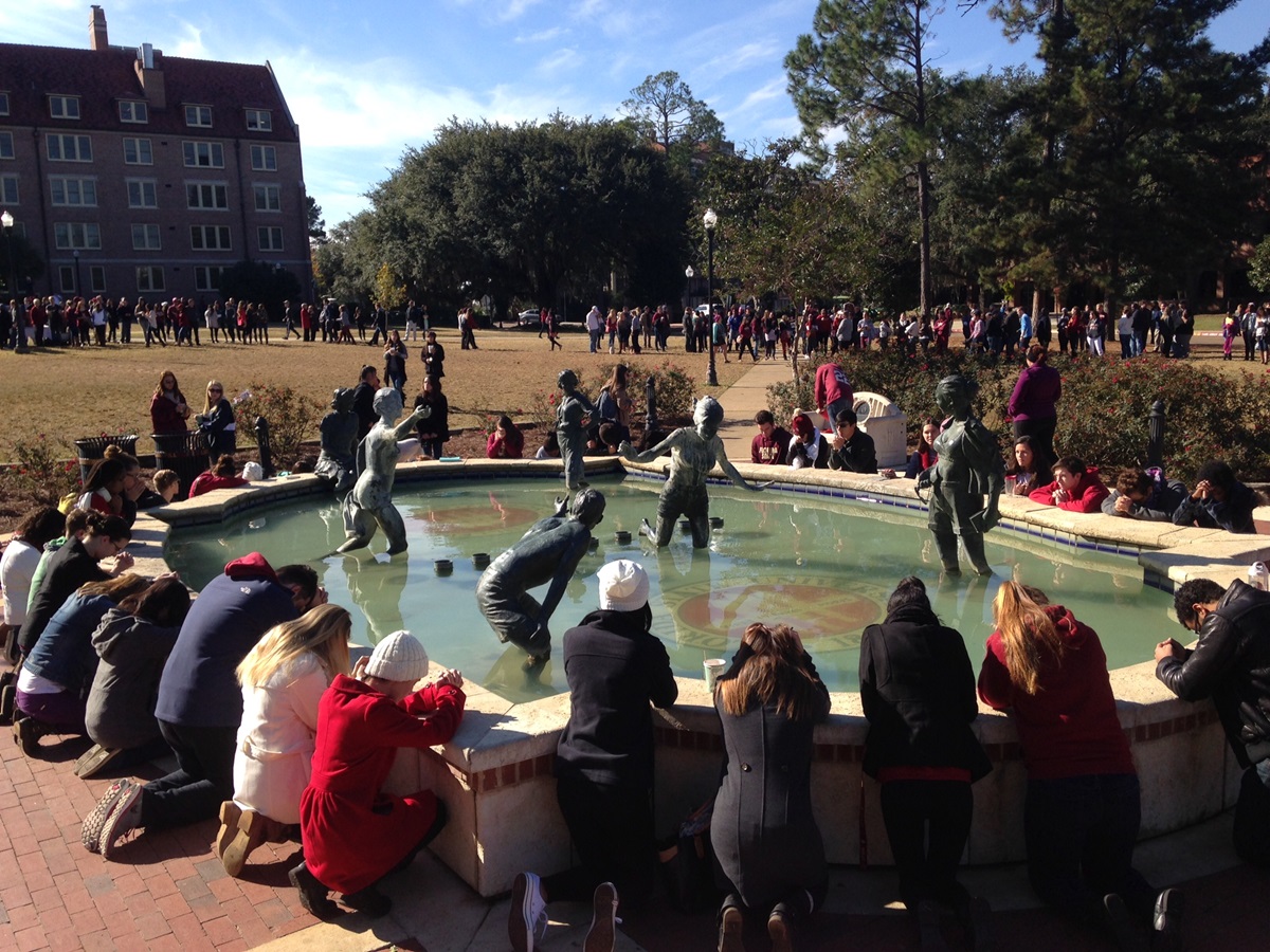 Members of the university community kneel in prayer during a service at Landis Green at Florida State University in Tallahassee following a shooting in the school's library. Photo by Alvaro Gabaldon, Florida State University