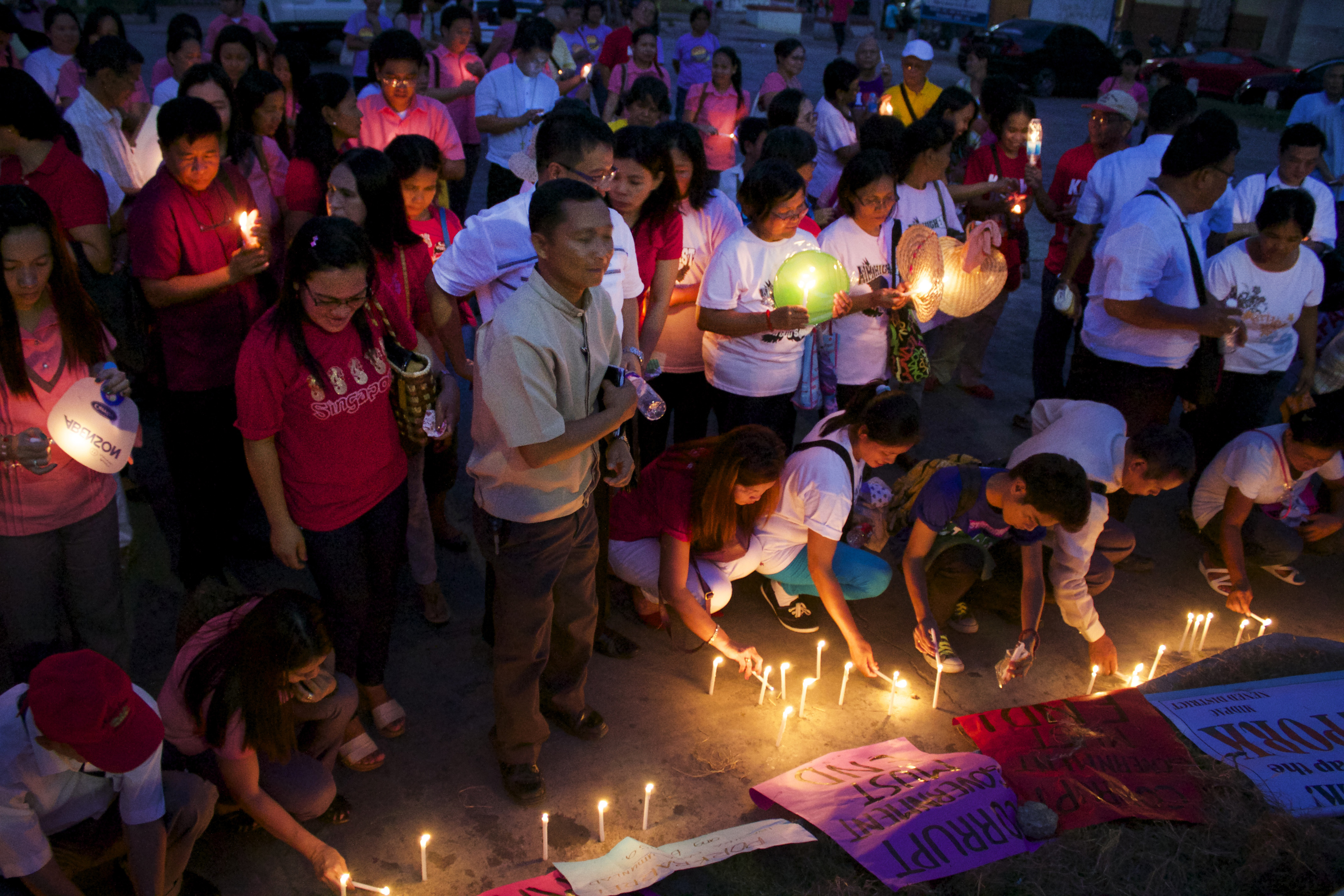Participants light candles to express their displeasure with government corruption in a vigil held on the Plaza Lucero in Cabanatuan City, Philippines. Photo courtesy of Gladys P. Mangiduyos