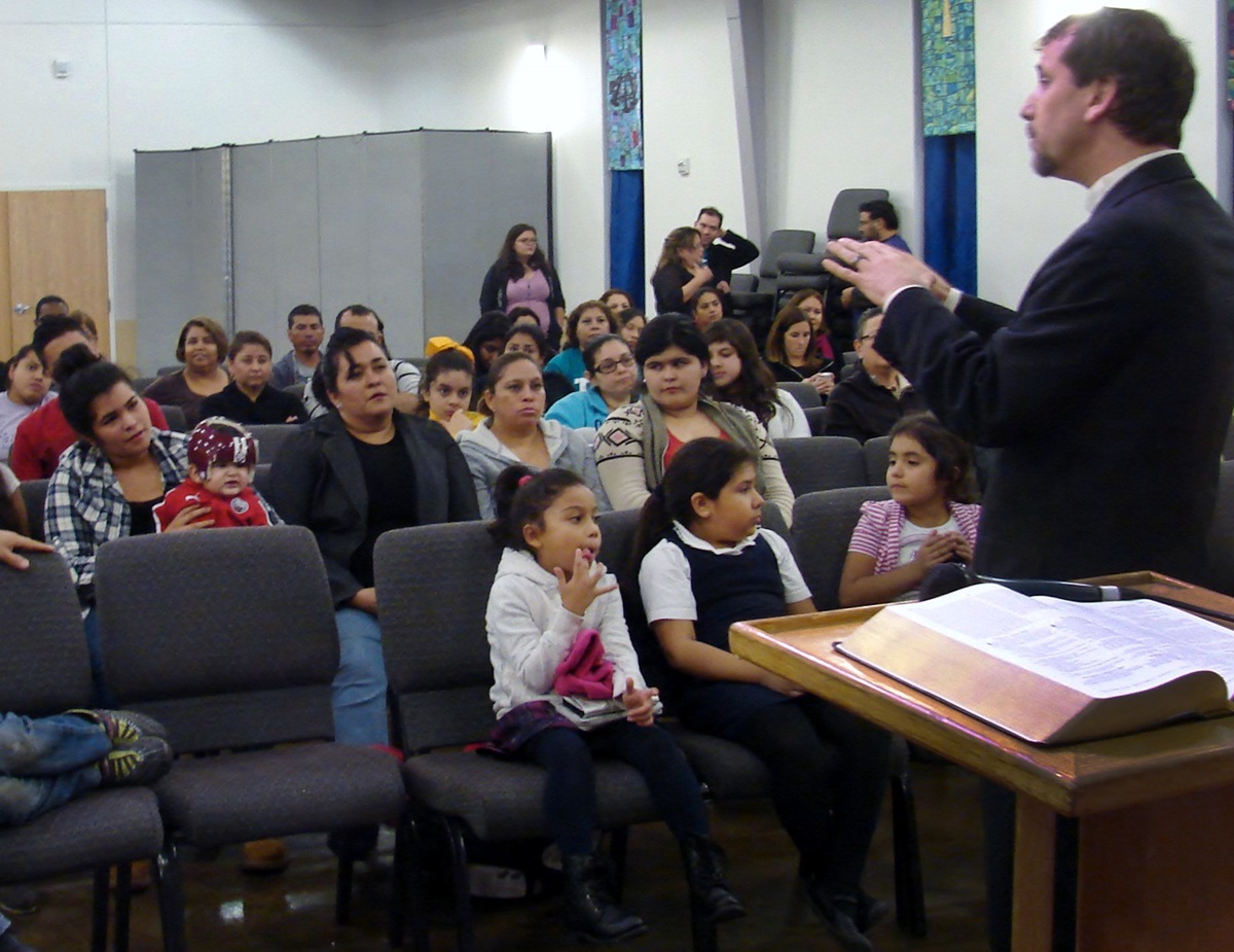 The Rev. Owen Ross, pastor of Christ's Foundry United Methodist Church in Dallas, speaks to the crowd at a watch party for President Obama's Thursday night (Nov. 20) address announcing executive actions on immigration. 