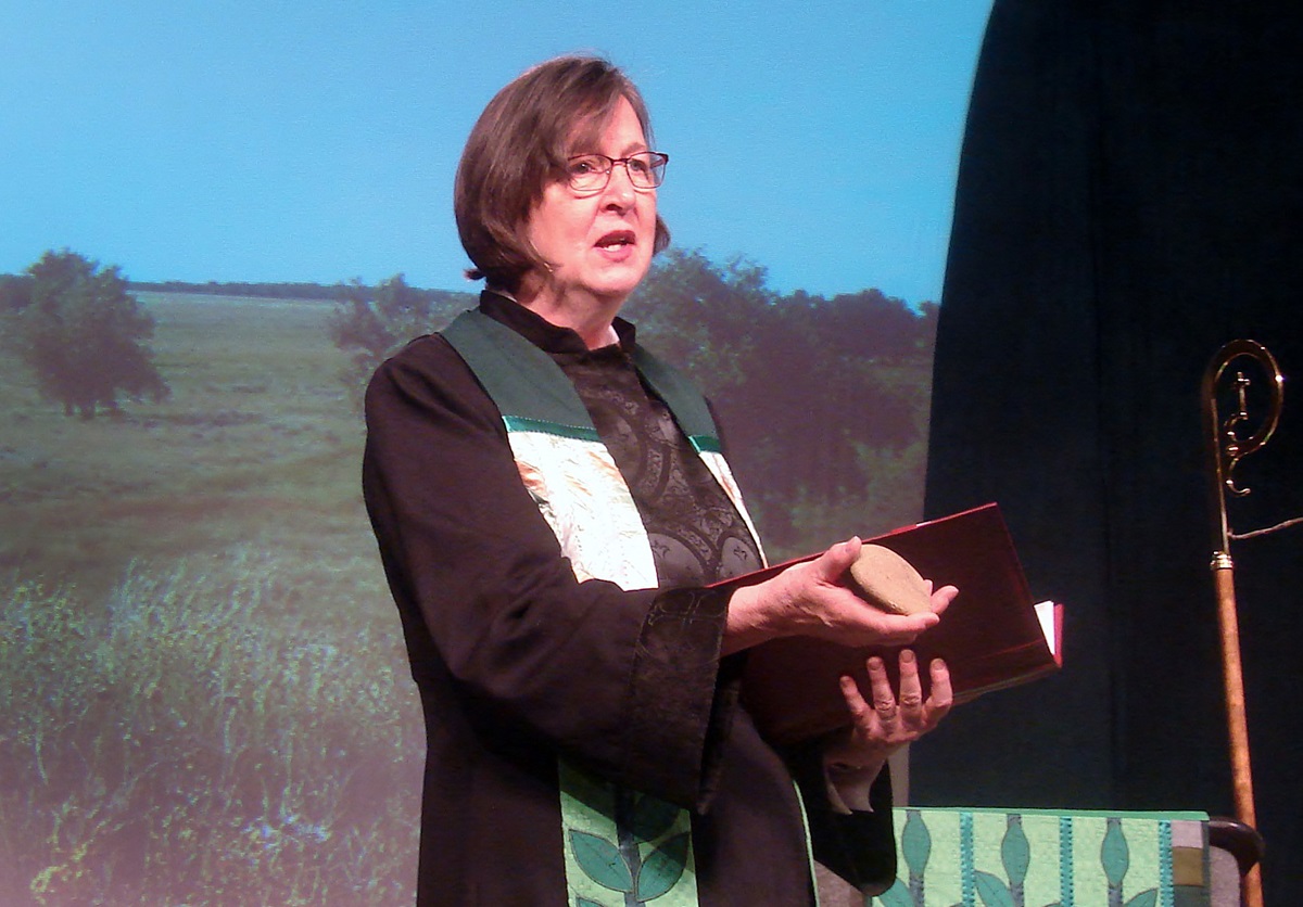 Bishop Elaine Stanovsky speaks about Sand Creek Massacre at the Rocky Mountain Annual Conference in Pueblo in June while holding a rock from Act of Repentance from the 2012 United Methodist General Conference.  Photo by Sam Hodges, UMNS