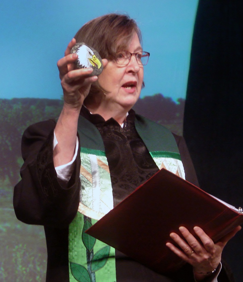 Bishop Elaine Stanovsky holds a rock painted by Gail Ridgely, a Sand Creek Massacre descendant. Photo by Sam Hodges, UMNS