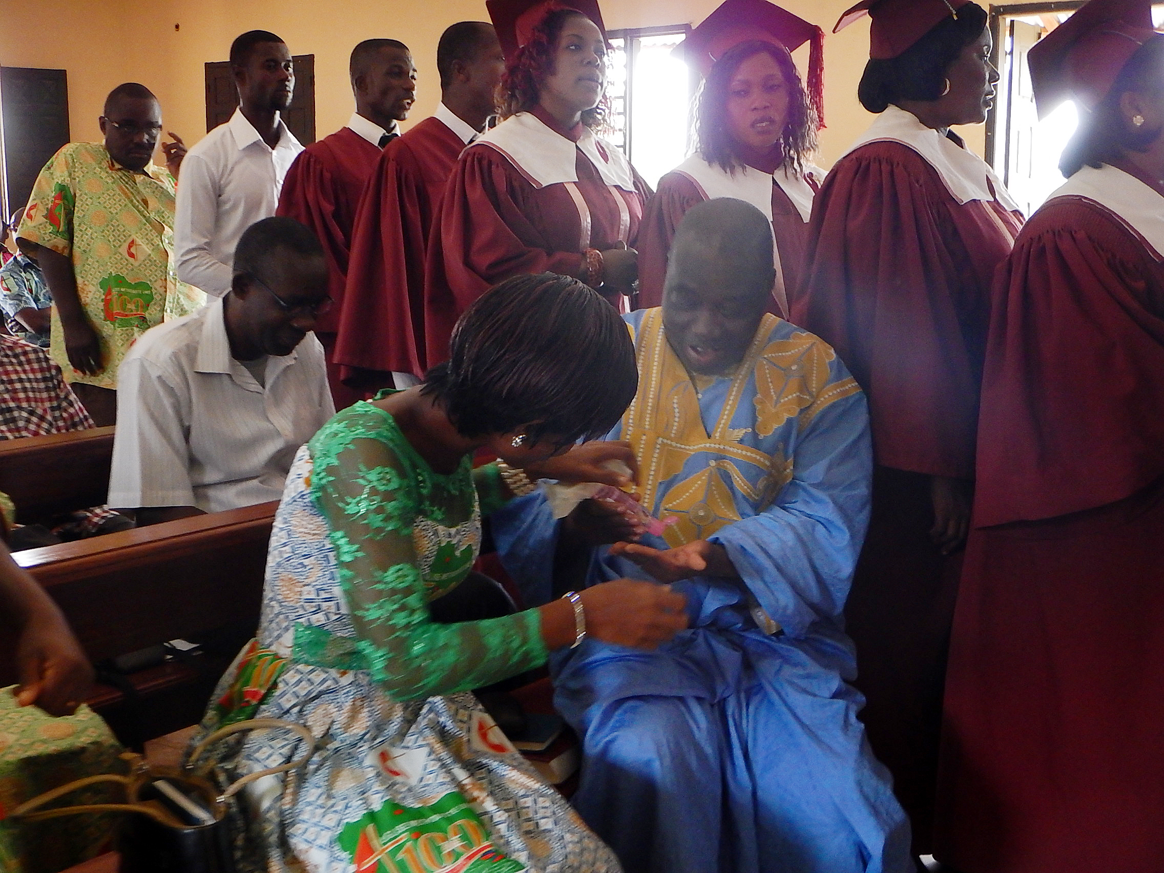 United Methodist preacher, Victor Gnangbi, and Claudia N’Guessan use hand sanitizer before communion at a United Methodist church in western Côte d’Ivoire. Photo by Isaac Broune, UMNS
