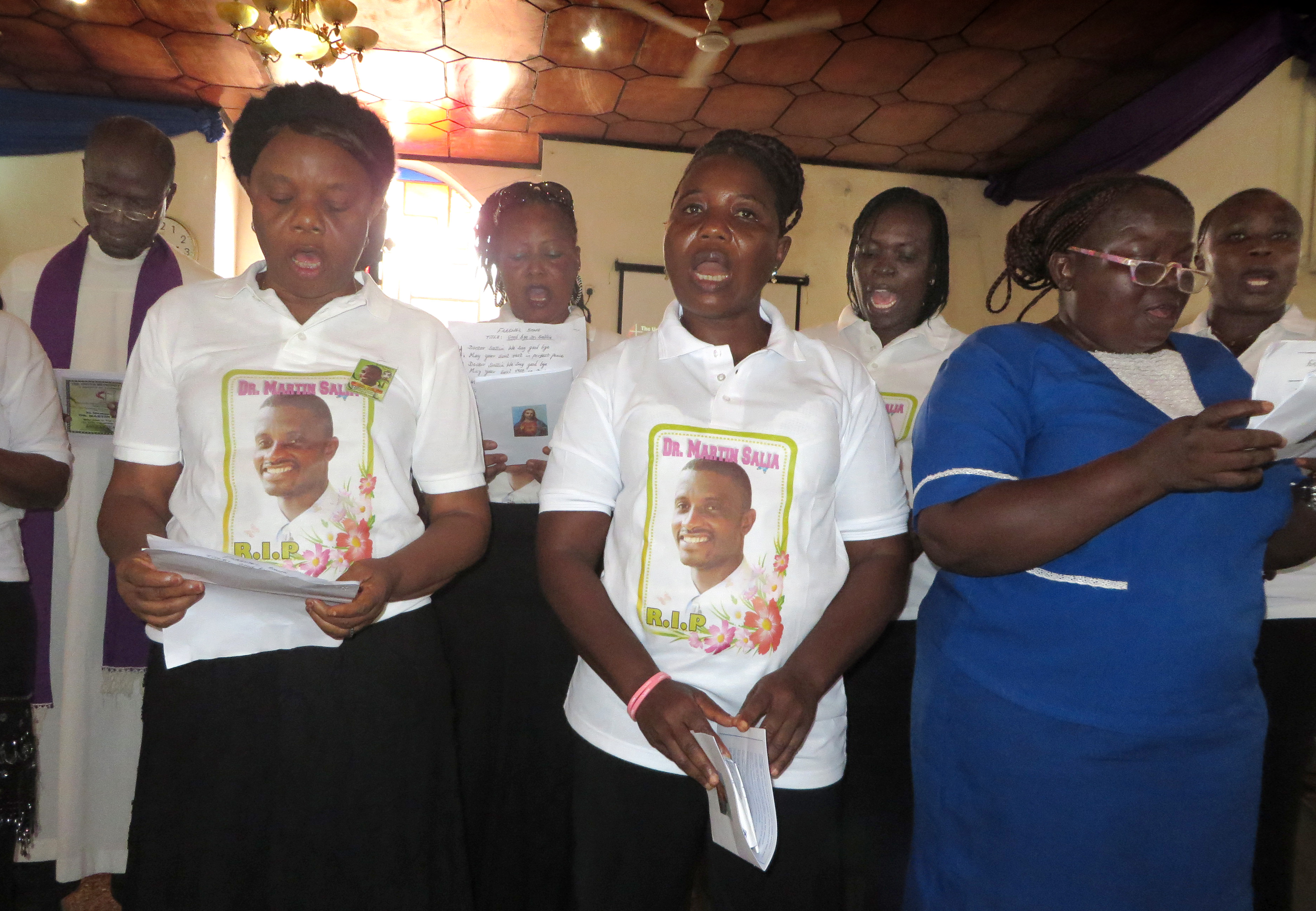 Staff members of Kissy United Methodist Hospital in Freetown, Sierra Leone, sing during a memorial service Dec. 2, 2014, for their colleague, Dr. Martin Salia, who died from Ebola. The service was held at Brown Memorial United Methodist Church, on the hospital grounds. Photo by Phileas Jusus, UMNS

