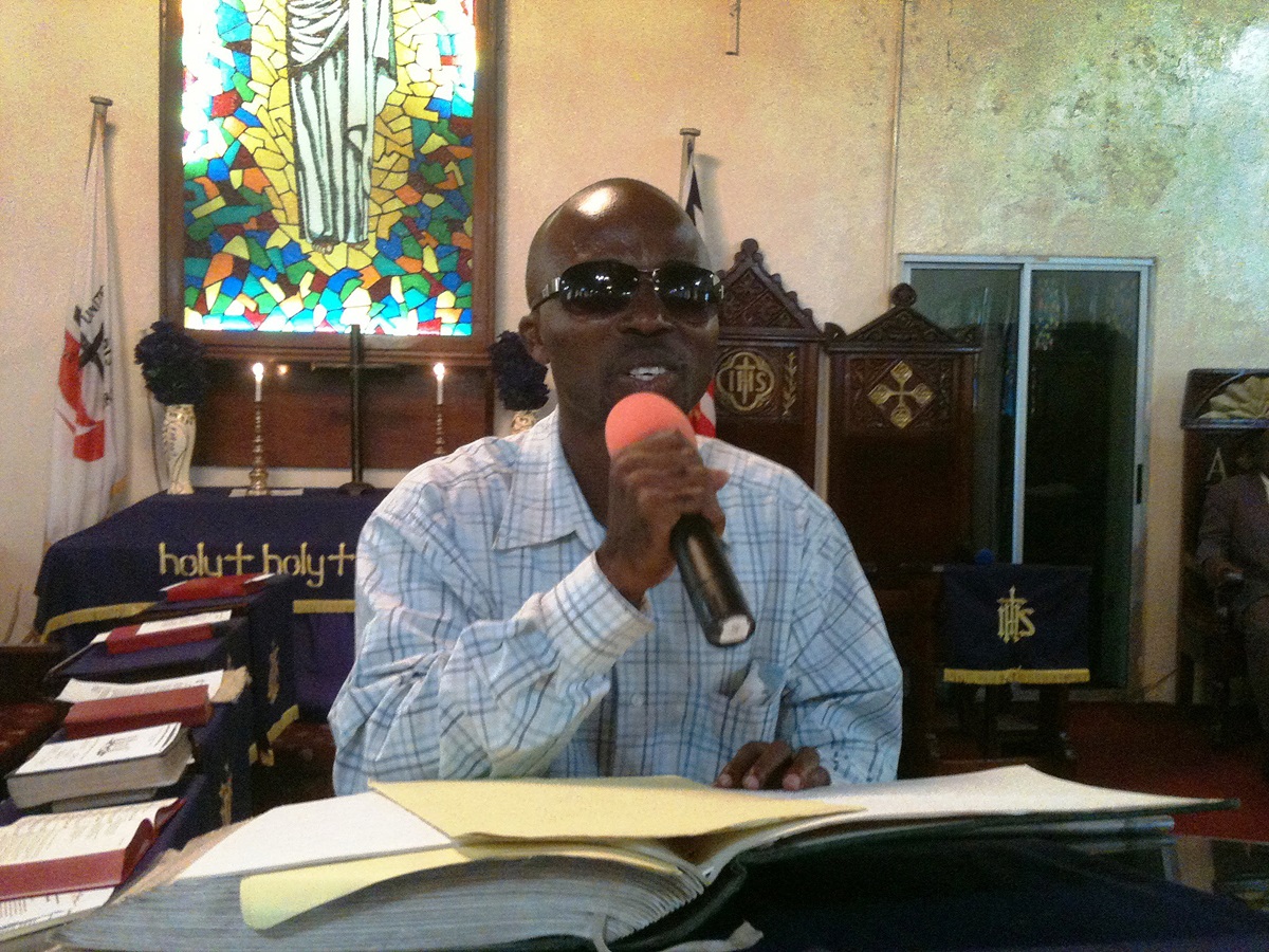 Joshua Shadra preaches using braille during the celebration of United Methodist Student Day at Stephen Trowen Nagbe United Methodist Church in Liberia. 