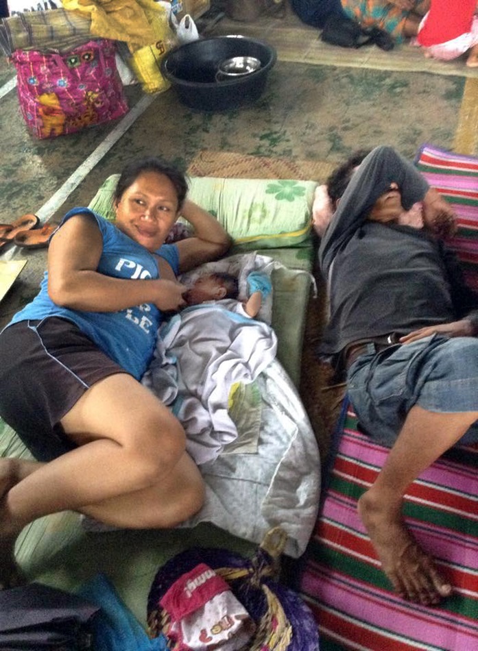 Myra Roble and her newborn baby, Jadelyn, take shelter inside the Sam Roque gymnasium in Isabel, Leyte, Philippines. Photo courtesy of Gladys Mangiduyos, UMNS