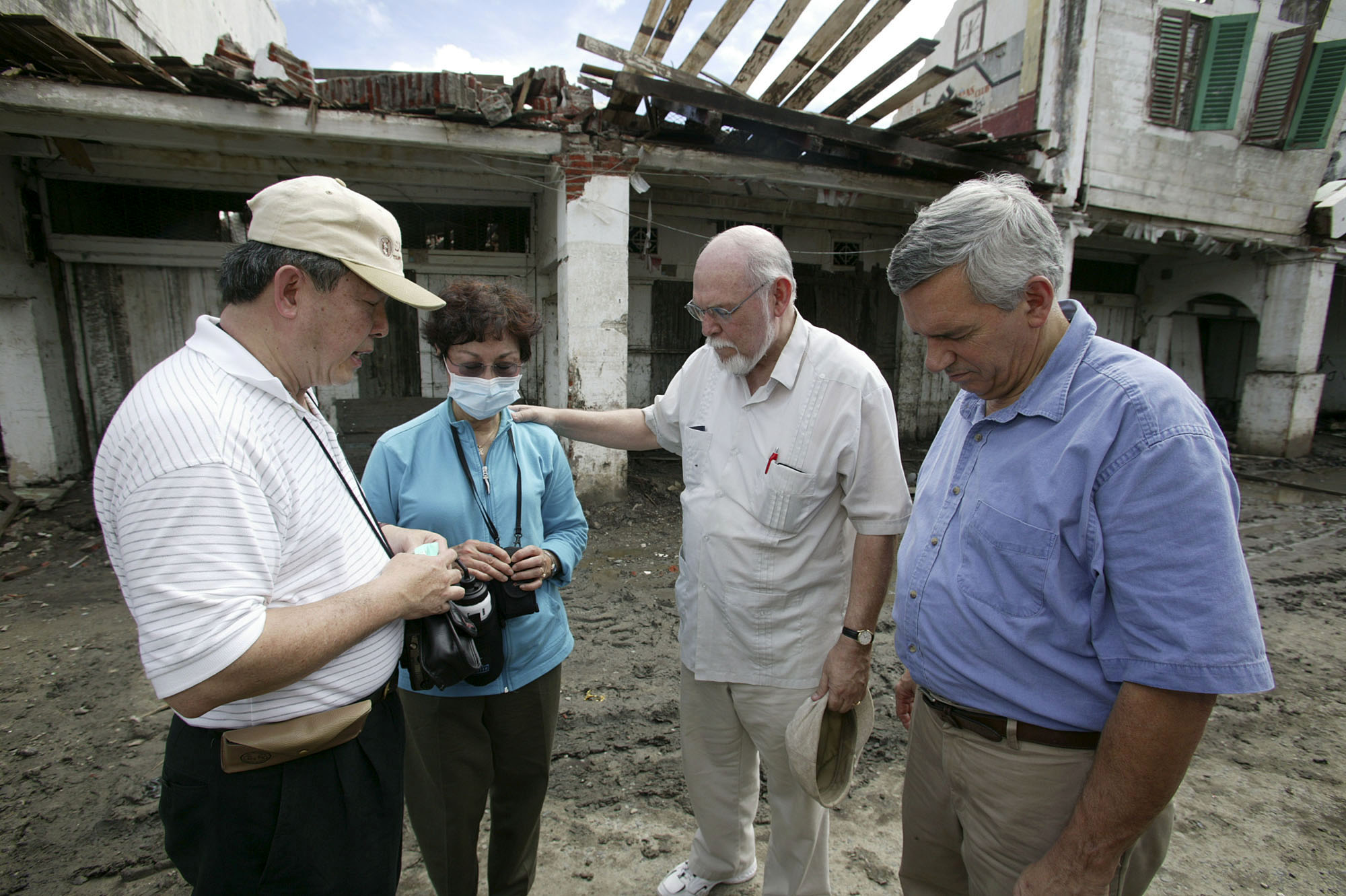 Members of a United Methodist delegation pray during a visit to Banda Aceh, Indonesia, three weeks after the tsunami. A UMNS photo by Mike DuBose.