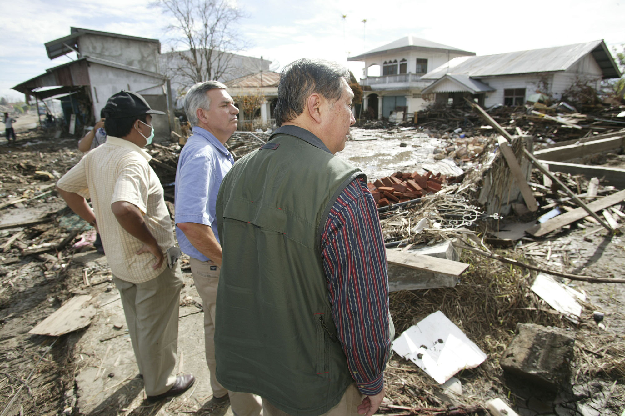 The Revs. David Wu (right) and R. Randy Day (center) of the United Methodist Board of Global Ministries view damage to Banda Aceh, Indonesia, following the Dec. 26 tsunami that killed thousands in the region. In January, a delegation of mission and communications leaders from the church visited areas of Sumatra, Indonesia, near the epicenter of the earthquake that triggered the waves.  Photo by Mike DuBose, United Methodist News Service
