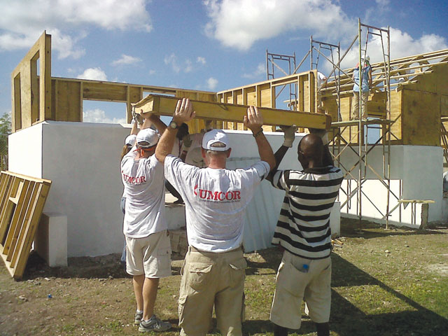 Workers from the United Methodist Committee on Relief, the Methodist Church of Haiti and United Methodist Volunteers in Mission help erect a Habitat for Humanity home in Leogane, Haiti, in November 2011. A UMNS photo courtesy Habitat for Humanity.