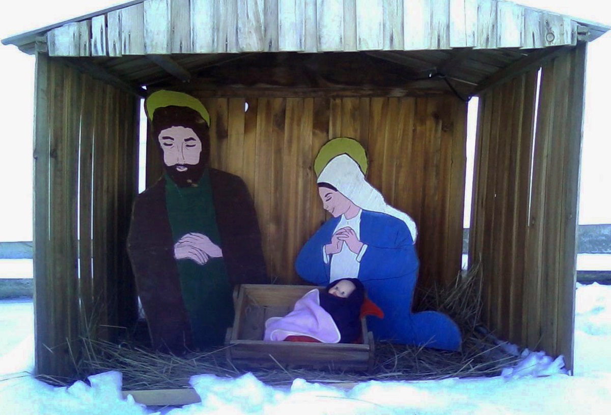 A manger scene created 35 years ago by Terry Pettengill’s Sunday school class graces the outside of Stetson United Methodist Church in Patten, Maine. Church member Rodney Harris, who passed away  earlier this year, built the creche in his wood shop. Photo by Ruth Foss.