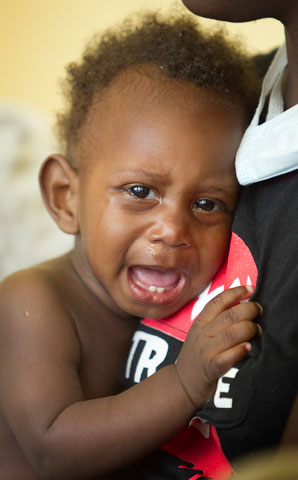 Laury Jean Baptiste cries while being examined at Grace Children's Hospital in Port-au-Prince, Haiti. A UMNS photo by Mike DuBose.
