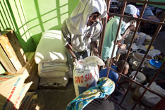 Workers move bags of flour in the Boutique Market in Port-au-Prince,Haiti, where the United Methodist Committee on Relief is buying supplies to feed 160 families in Mellier.