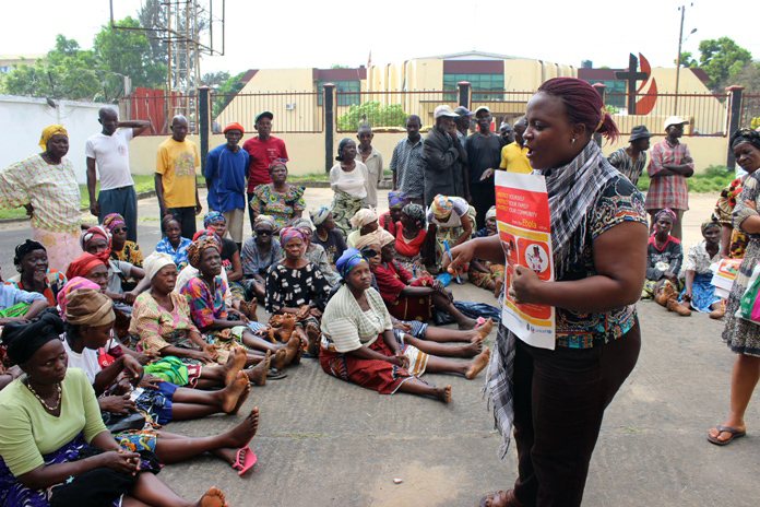 During the food distribution at The United Methodist Church’s central office in Liberia, Victoria Tomah, the denomination’s director of Health and Social Welfare, lectured the beneficiaries on several Ebola preventive measures. Photo by Joseph Zeogar 