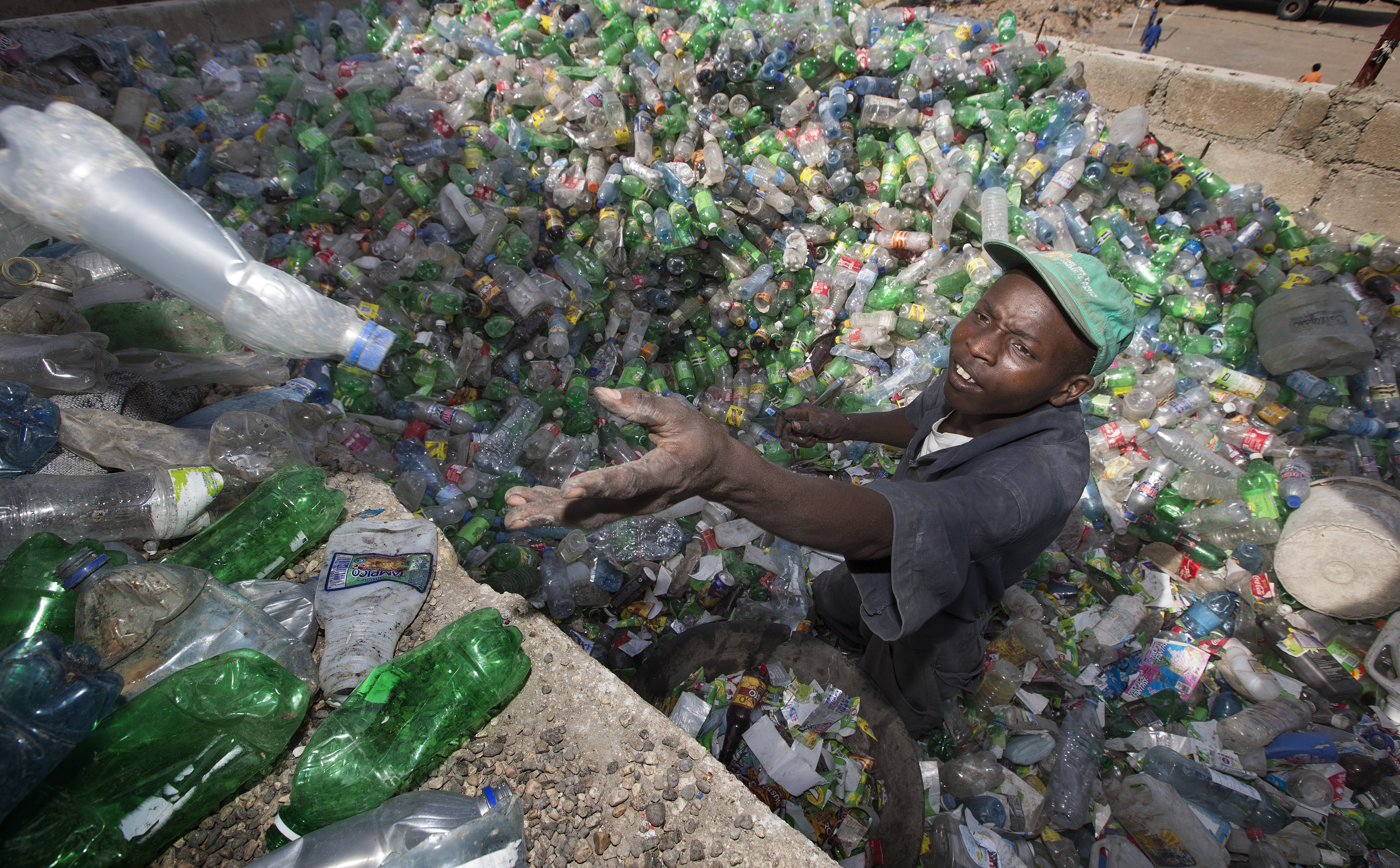Janvier Jackson sorts plastic bottles for a recycling program sponsored in part by the United Methodist Committee on Relief in Port-au-Prince, Haiti. The program will help reduce solid waste and provide income to collectors and recycling center employees. Photo by Mike DuBose, UMNS