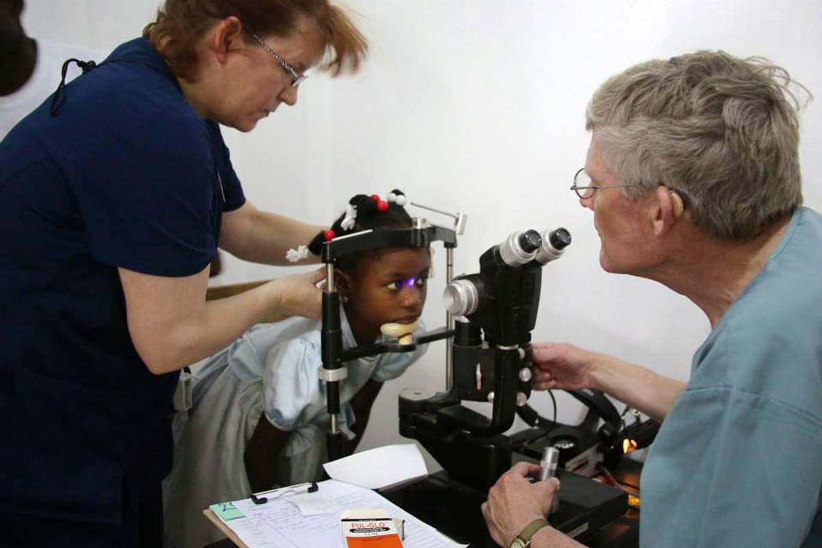 Dr. Gary Fish (right) and assistant Carrie Tarter see a young patient in Highland Park United Methodist Church’s eye clinic in Petit-Goâve, Haiti. One of the clinic’s buildings was destroyed by the earthquake that rocked Haiti on Jan. 12, 2010, and the church built back, dedicating the new structure on Jan. 12, 2014. File photo courtesy of Highland Park United Methodist Church