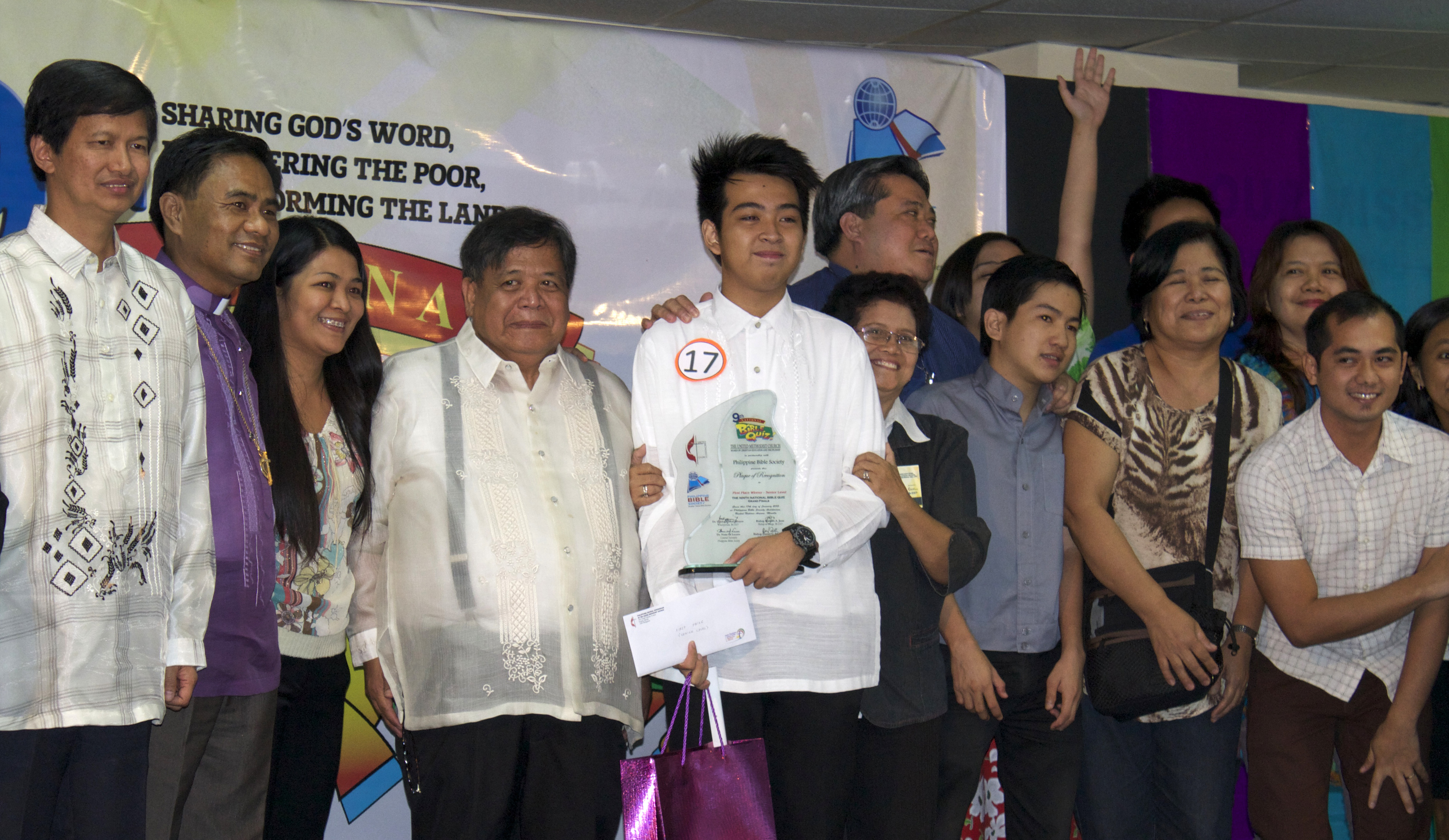 Alexis John Caguingin holds his trophy after winning the senior division of the National Bible Quiz held in Manila, Philippines. 