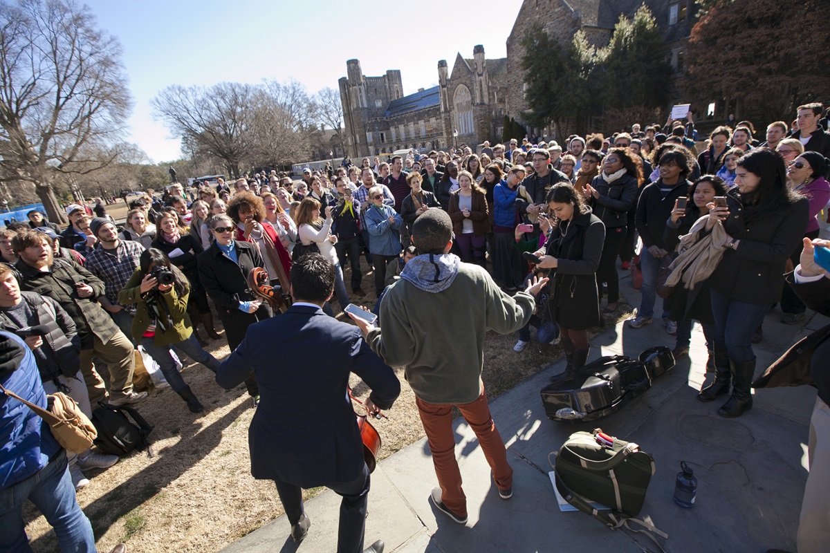 Duke University students Matthew Bunyi (left)  and Richard Phillips led a crowd outside Duke Chapel in song before the start of the adhan, the Muslim call to prayer, on January 16, 2015. University officials cancelled plans to have the call to prayer offered from the chapel's bell tower, but allowed it from the chapel's steps. Photo by Megan Morr, © Duke Photography
