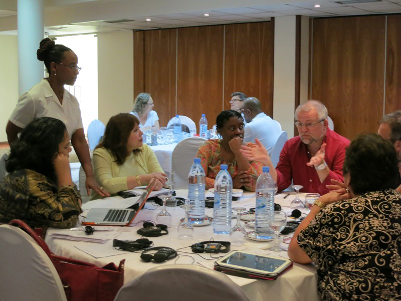 Connectional Table members spoke in small groups about different legislative approaches to the denomination's sexuality debate during their meeting in Maputo, Mozambique. Pictured from far left are Monalisa Tuitahi, the Rev. Kennetha Bigham-Tsai (standing), Bishop Minerva Carcaño, the Rev. Tamara Brown, the Rev. Ole Birch, the Rev. Harald Rückert and Josephine Deere. Photo by Heather Hahn, UMNS