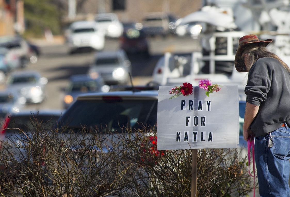 A sign asking people to pray for Kayla Mueller, an ISIS held Arizona aid worker, is posted in downtown Prescott, Ariz. 