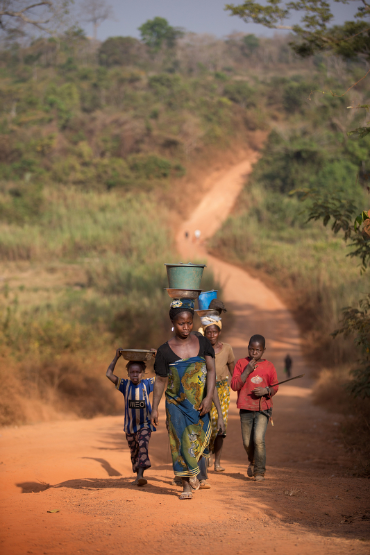 A family makes its way along the road outside Sipilou, near the border with Guinea. 