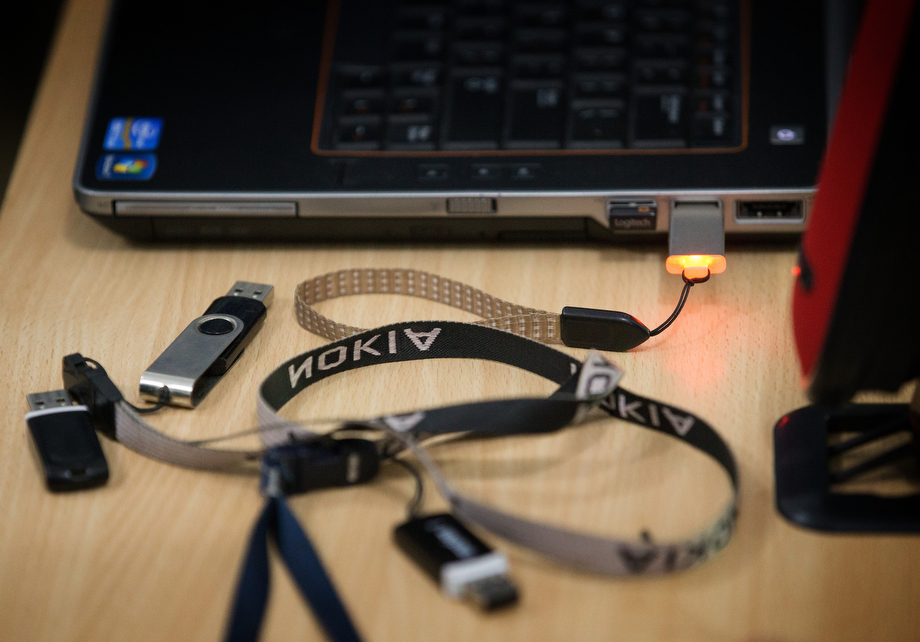 Computer memory sticks belonging to health workers are gathered to receive copies of a video presentation about preventing the spread of Ebola in Man.