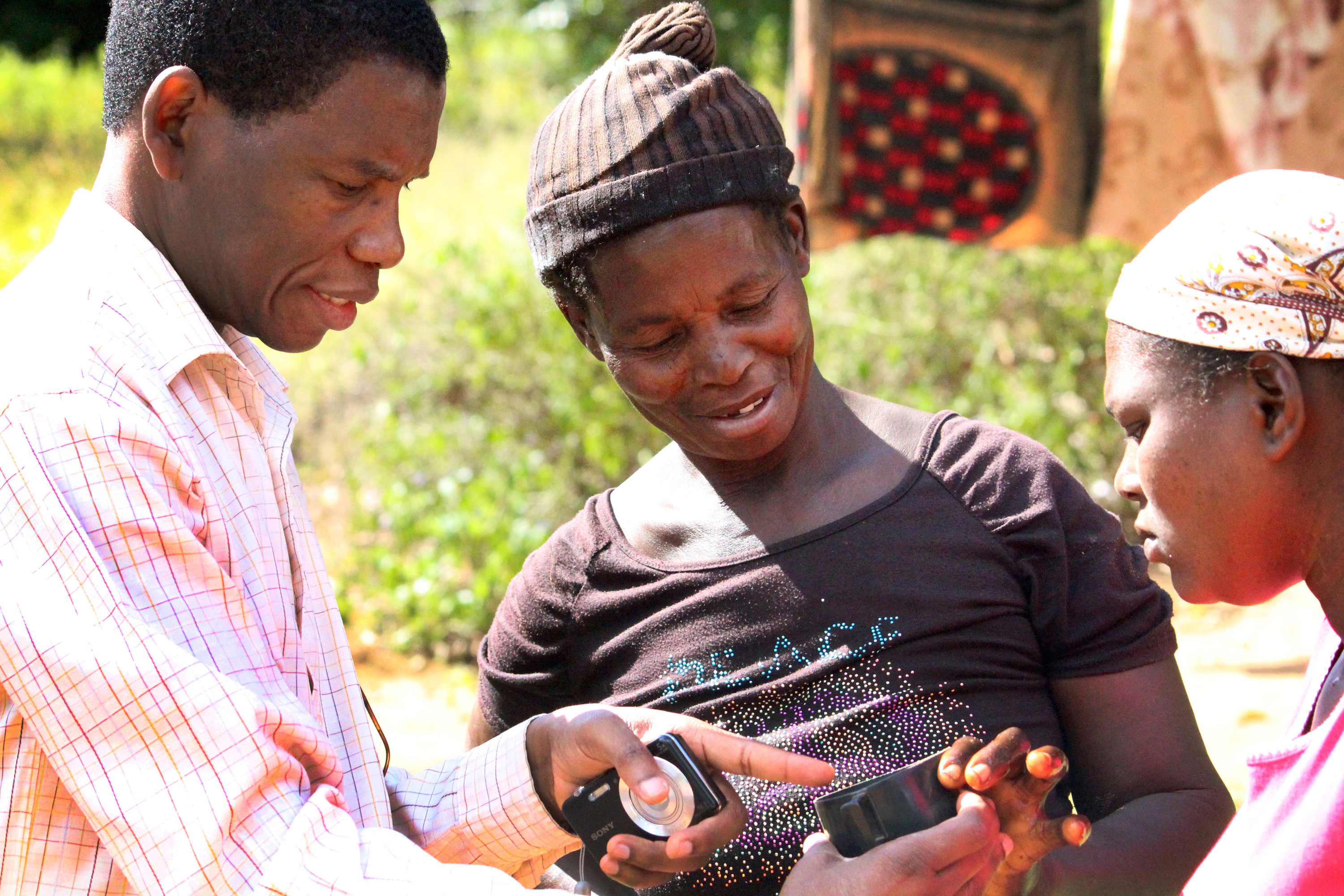 The Rev. Alindo Romão shows mosquito larvaes to women in this 2014 photo. File photo, Imagine No Malaria