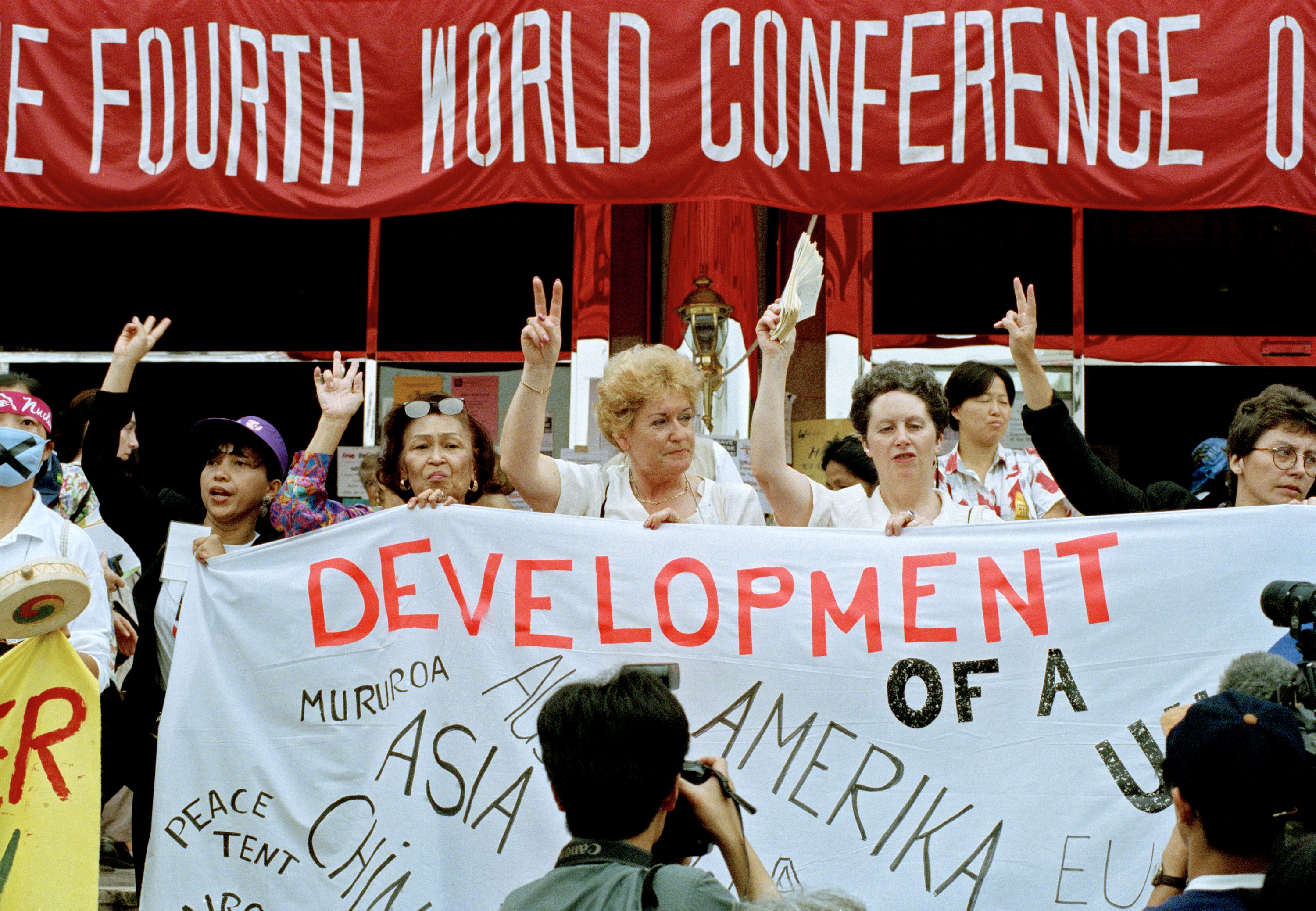 Participants carry a sign during the forum for nongovernmental organizations in Huairou, China, part of the 1995 U.N. Fourth World Conference on Women. Photo by Milton Grant, U.N.