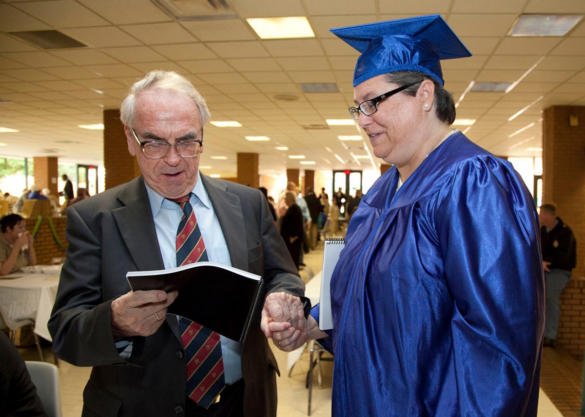 Jürgen Moltmann (left), a German theologian, who became friends with Kelly Gissendaner and exchanged letters with her over the years attends her 2011 graduation ceremony at Arrendale State Prison.