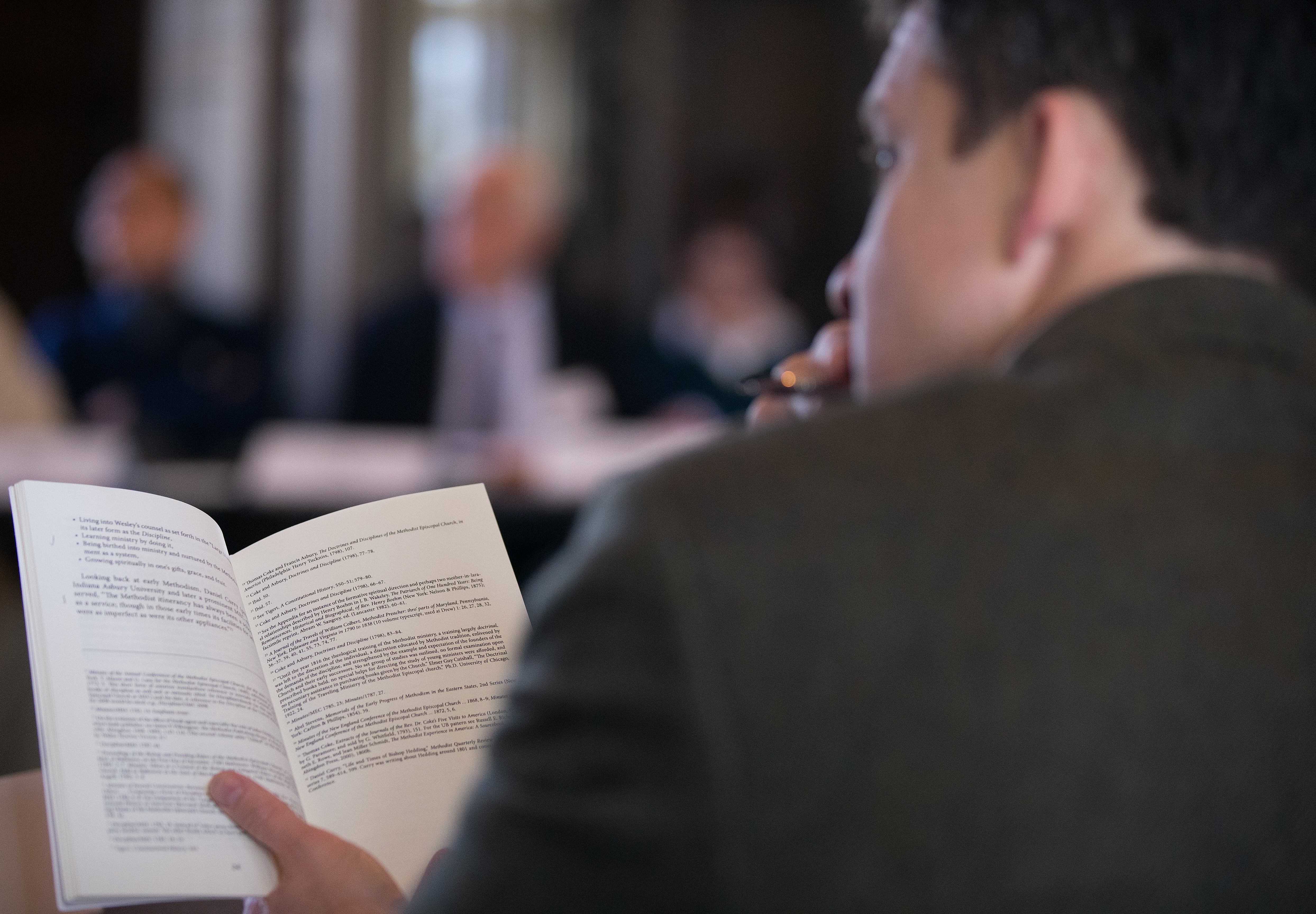 Attendees read from the book "Formation for Ministry in American Methodism," by the Rev. Russell Richey during a panel discussion on theological education at the Scarritt Bennett Center in Nashville, Tenn. Photo by Mike DuBose, UMNS