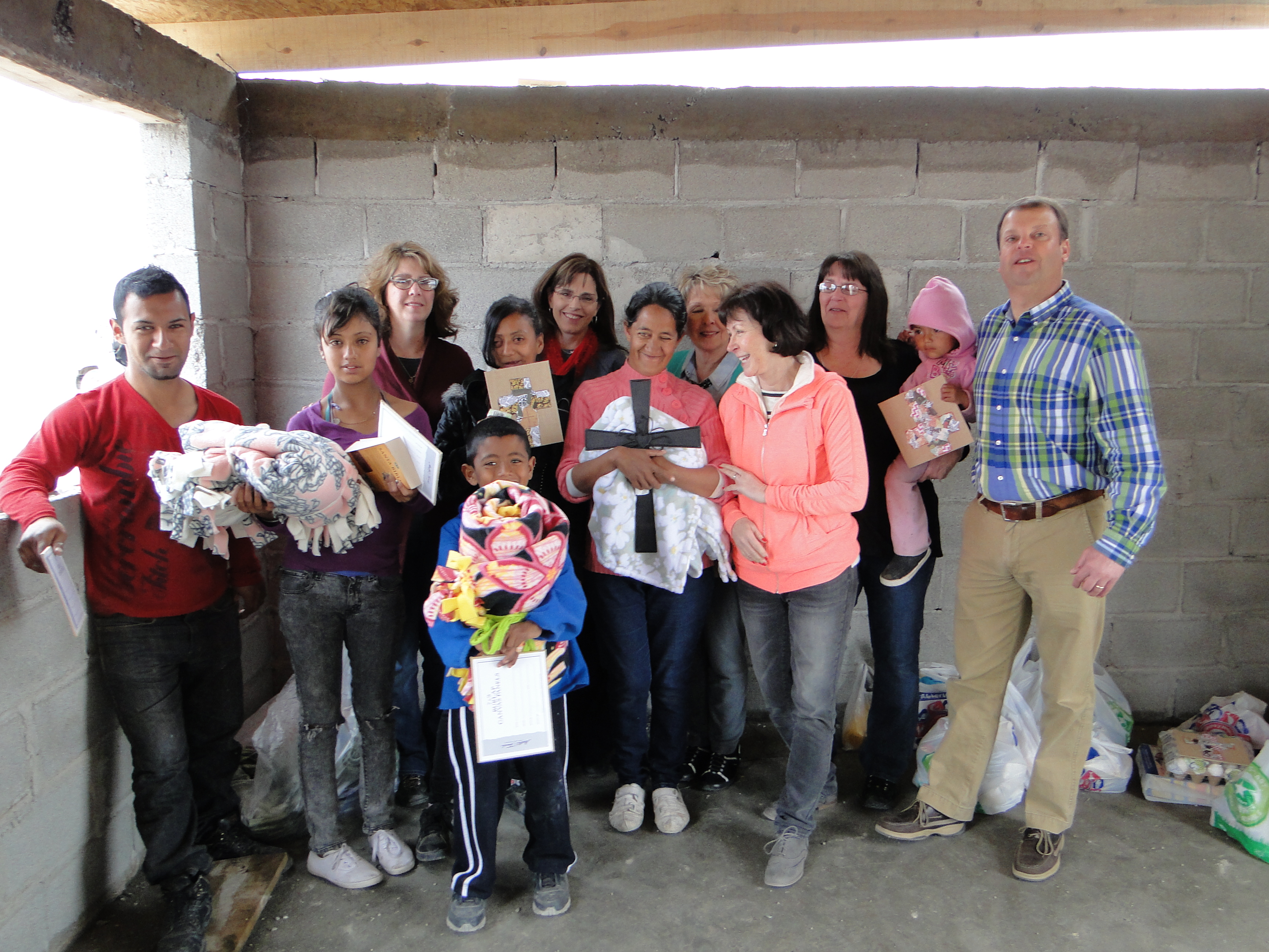 Mission team members from Suncreek United Methodist Church helped build a cinder-block home last month for the Quinoñes family of Ciudad Juárez, Mexico, and posed with the family after a dedication service. Photo courtesy Janet Hunt, Suncreek United Methodist Church.