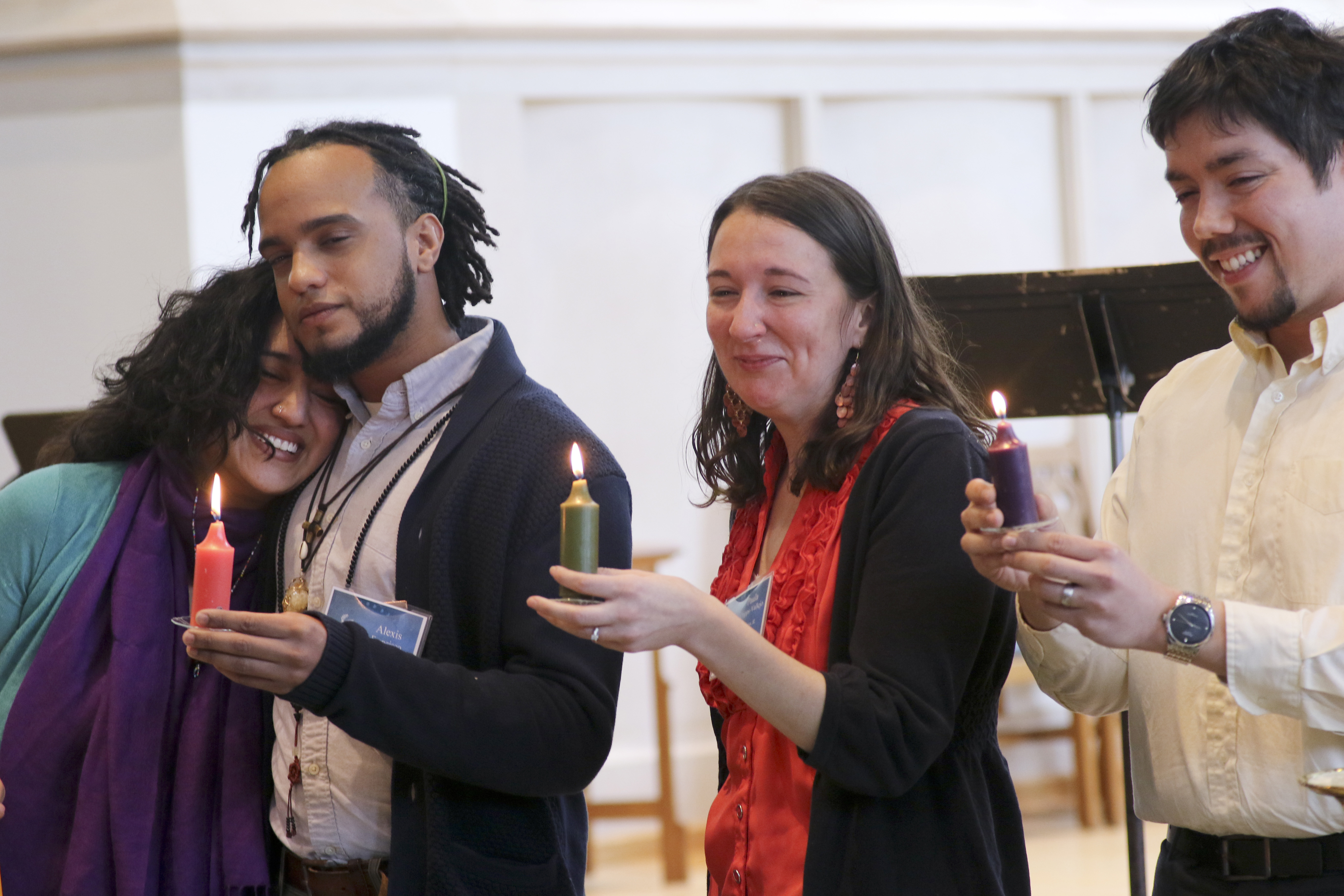 Four young leaders hold a lit candle symbolizing that they have the power within them to do amazing things during the third  National Consultation on Hispanic/Latino Ministry. Photo by Arthur McClanahan, Iowa Conference
