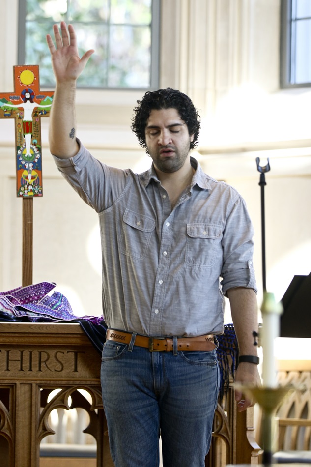 Adrian Federico Apecena, student at Duke Divinity School,  raises his arm in prayer during the third National Consultation on Hispanic/Latino Ministry held at Duke University Divinity School in Durham, N.C. The event took place March 12-14, 2015. Photo by Arthur McClanahan, Iowa Conference
