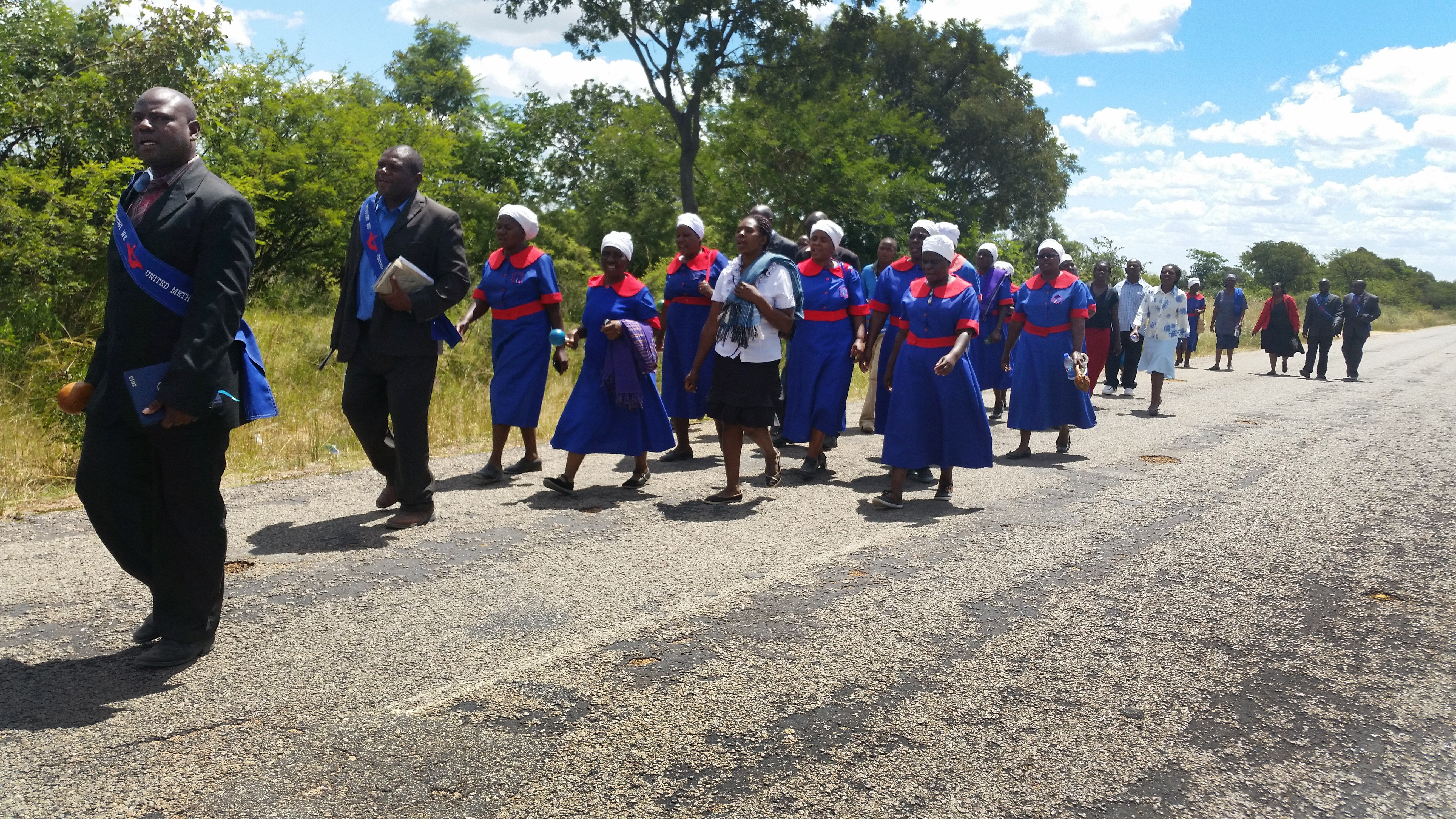 The United Methodist evangelism team from the Chitungwiza-Marondera district walk over 6km preaching and inviting residents during a three-day revival in Mahusekwa, Zimbabwe. In this photo, the team is enroute to their final stop, the Mahusekwa Government Hospital.  