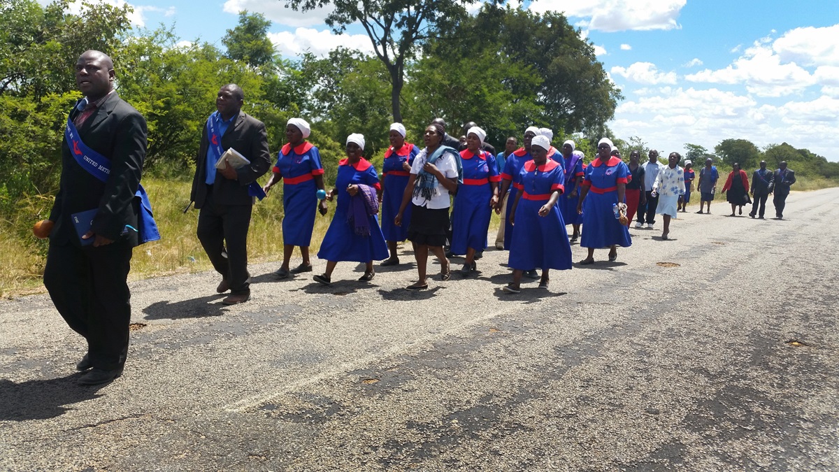 The United Methodist evangelism team from the Chitungwiza-Marondera district walk over 6km preaching and inviting residents during a three-day revival in Mahusekwa, Zimbabwe. In this photo, the team is enroute to their final stop, the Mahusekwa Government Hospital.  