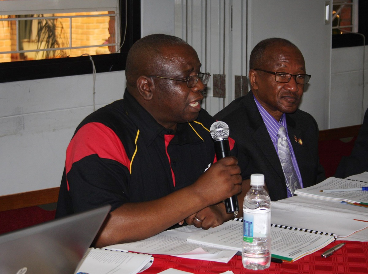 Munashe Furusa, Africa University's new vice chancellor,  reports to the board of directors on issues facing the United Methodist school, including the need for more on need for more faculty with doctorates. Bishop Marcus Matthews, right, listens to the report. Photo by Vicki Brown, UMNS
