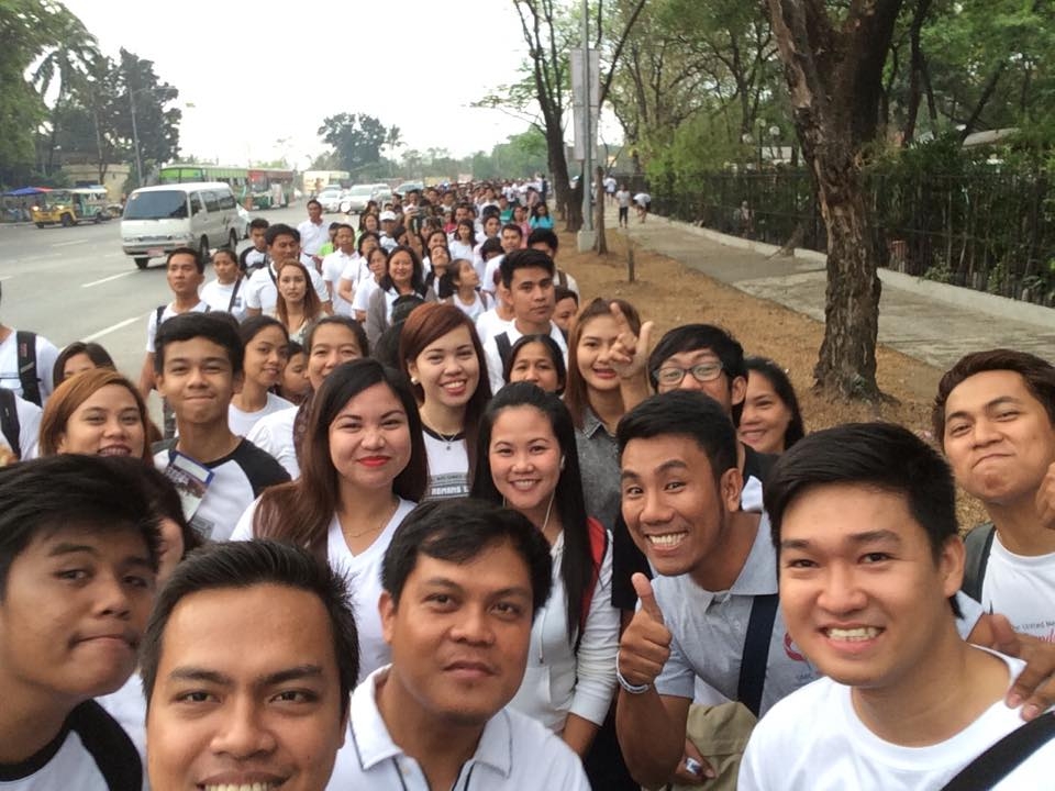 Students from Wesley Divinity Seminary, Wesleyan University, flash smiles and signs of affirmation during a March 21 United Methodist family march and rally in Quezon City, Philippines. Photo by SJ Earl Canlas and Jimuel Mari